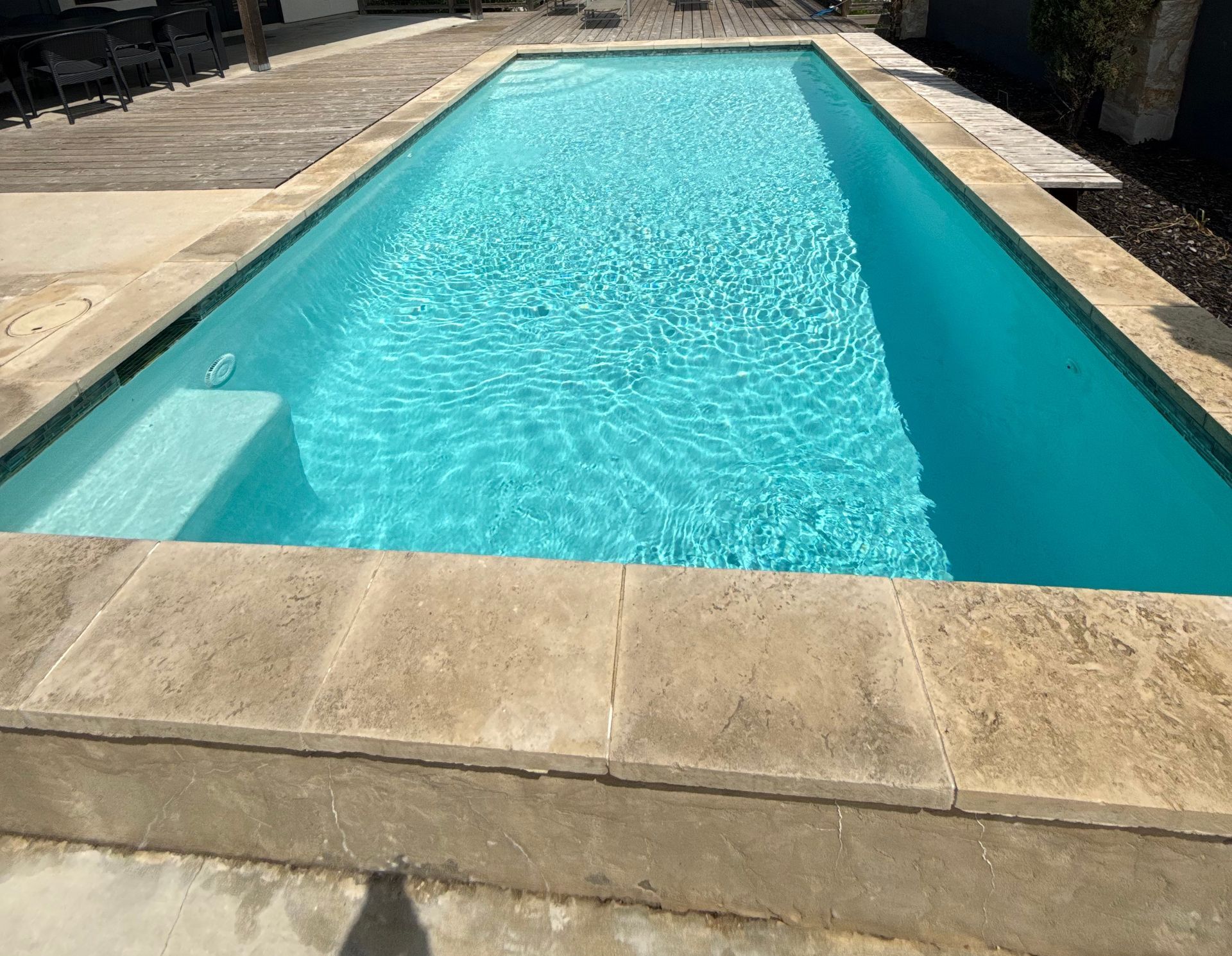 A large swimming pool with stairs leading to it