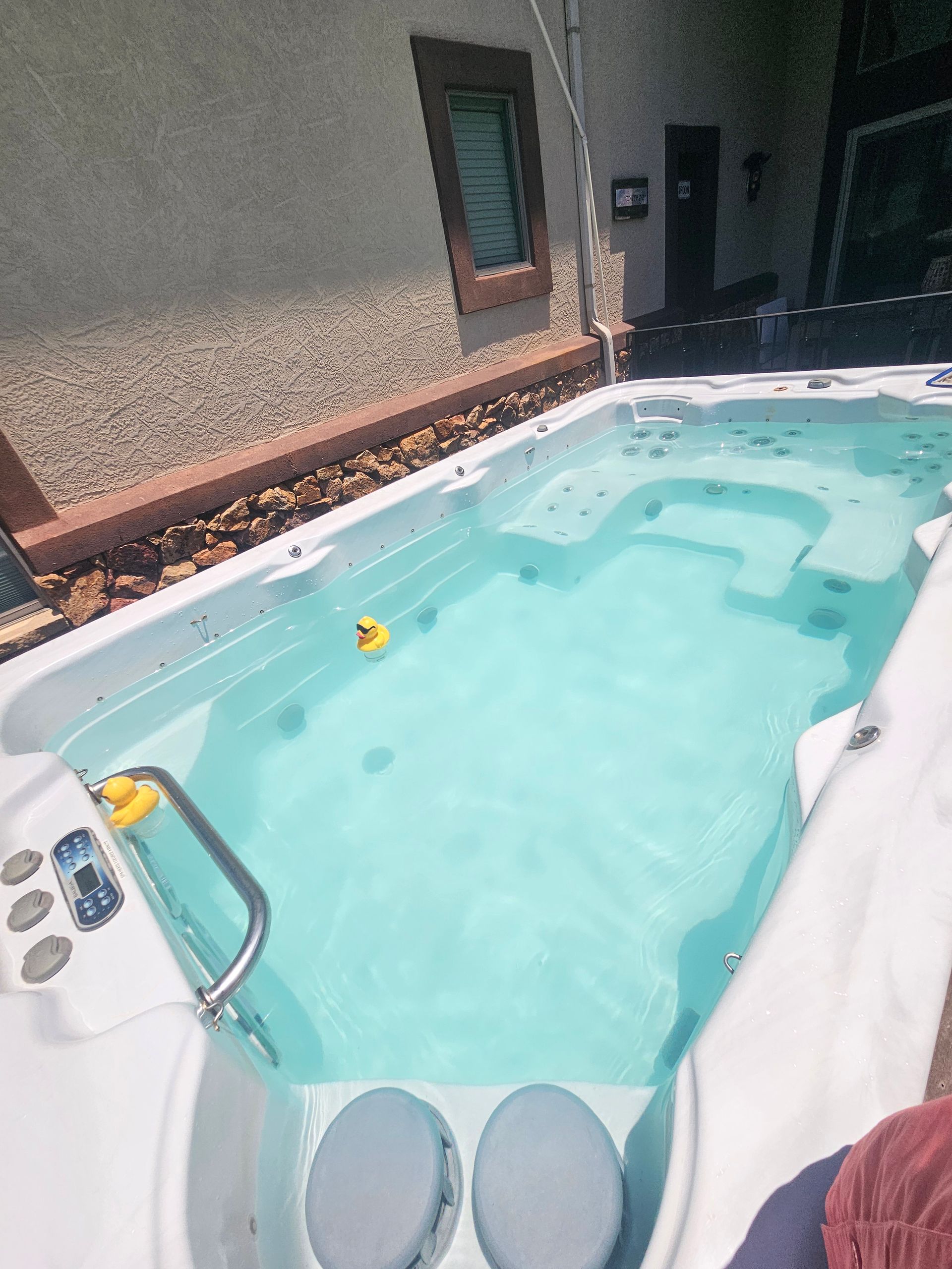 A large swimming pool with a yellow rubber duck in it.