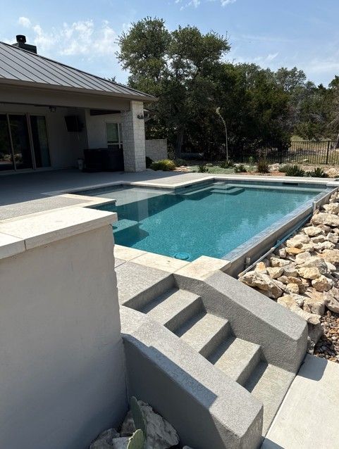 A large swimming pool with stairs leading to it