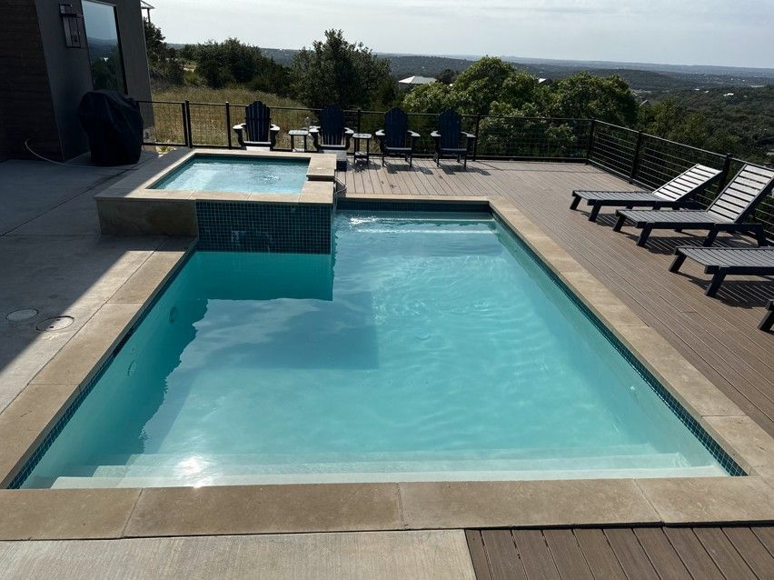 A large swimming pool surrounded by chairs and a deck