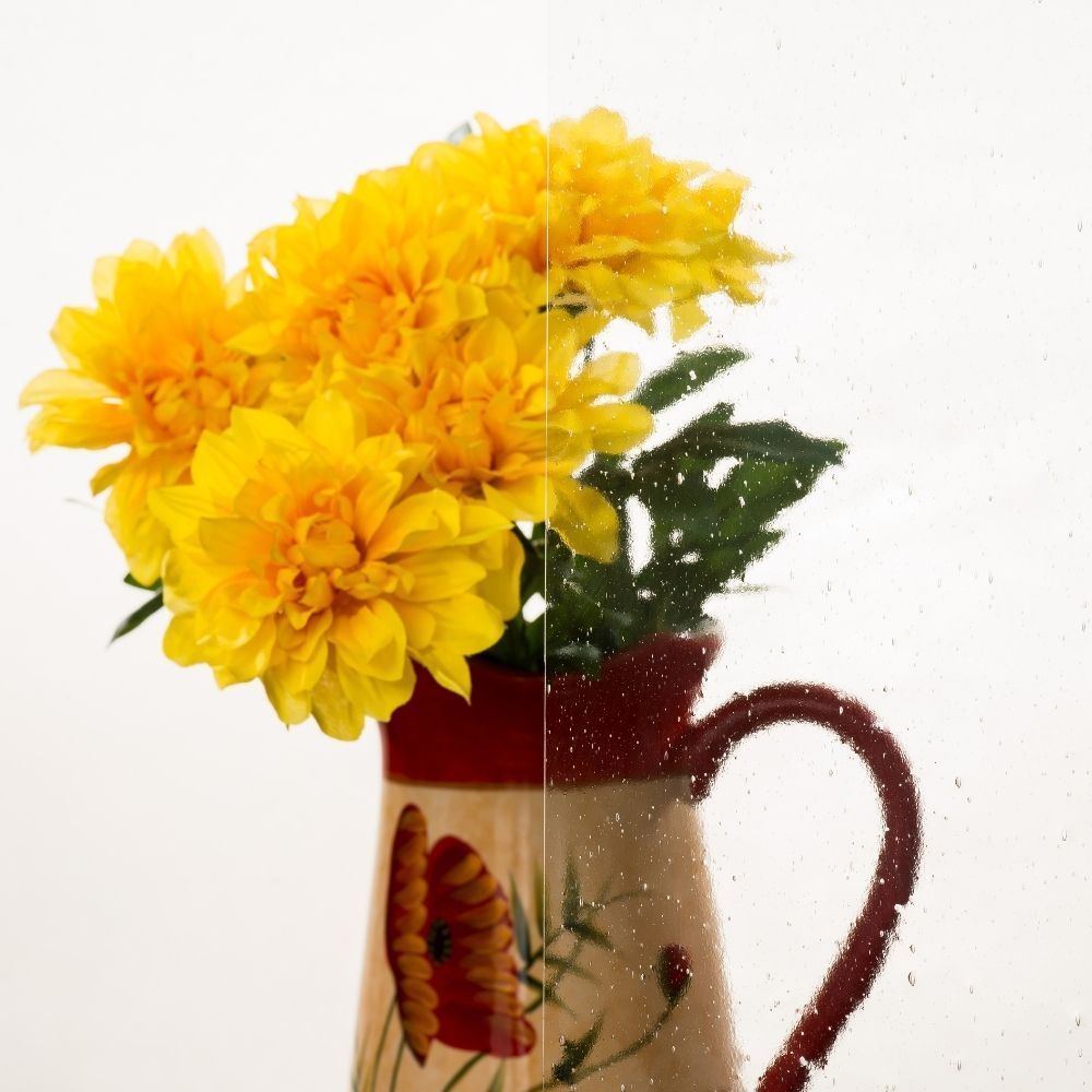 Yellow flowers in a red mug with a butterfly design on a white background