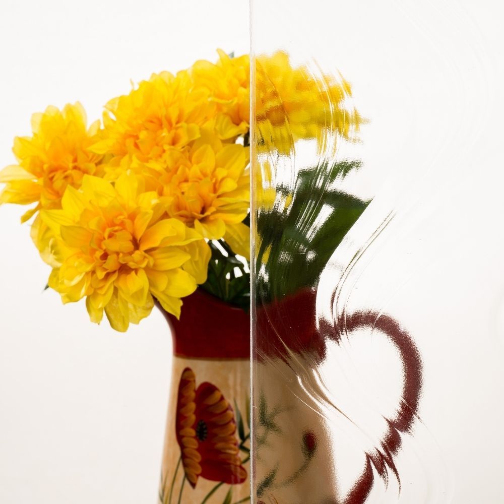 Yellow flowers in a ceramic pitcher on a white background