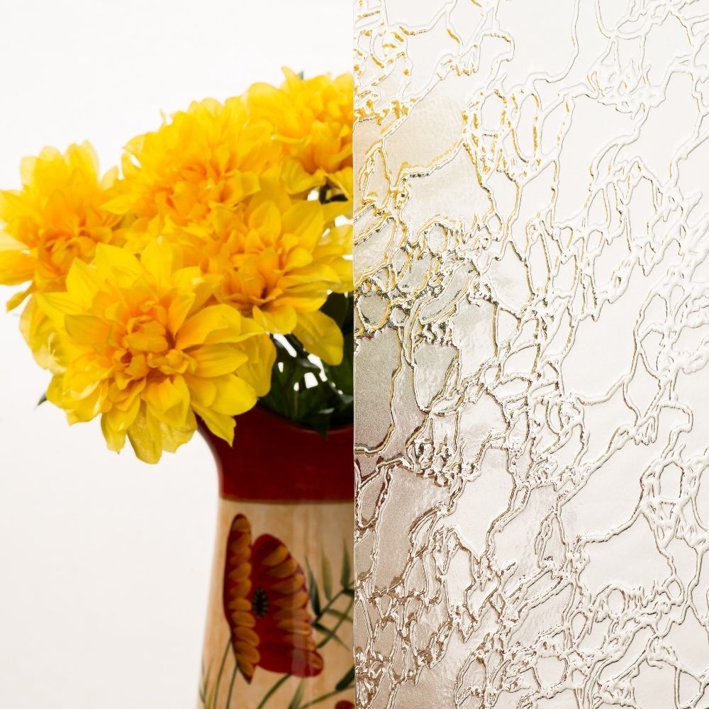 Yellow flowers in a vase beside a textured beige wall