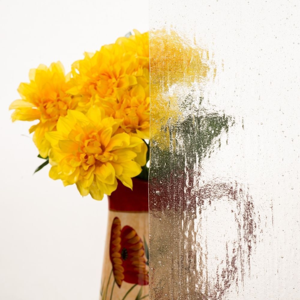Yellow flowers in a vase, dissolving into a textured white background