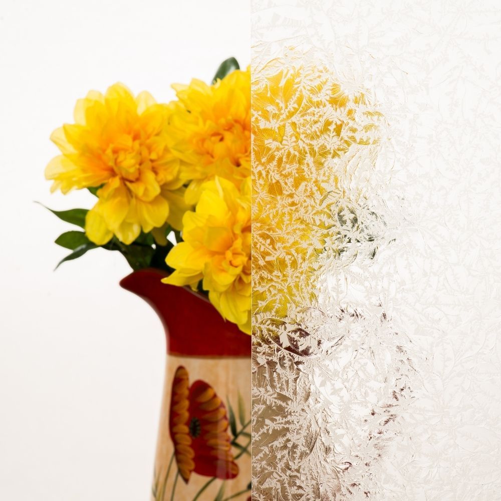 Yellow flowers in a red-and-white vase, dissolving into a pixelated white fade on the right