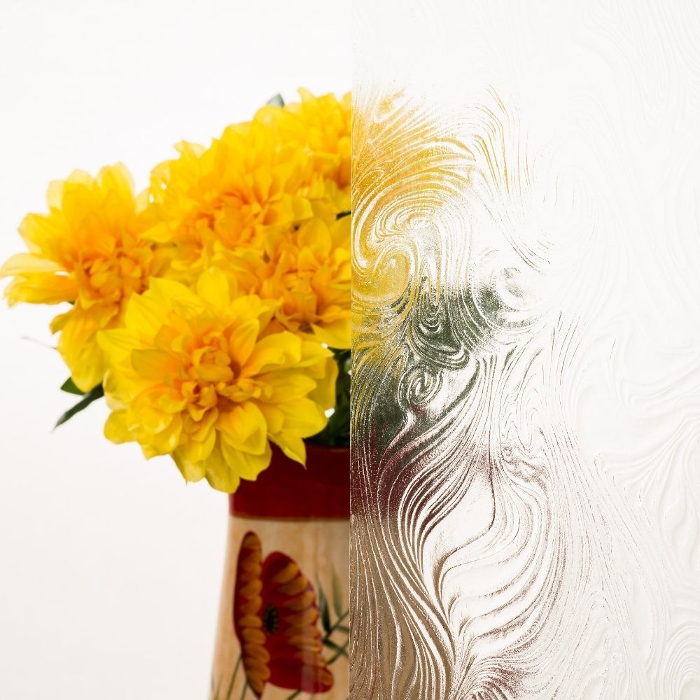 Yellow flowers in a decorative vase against a white background