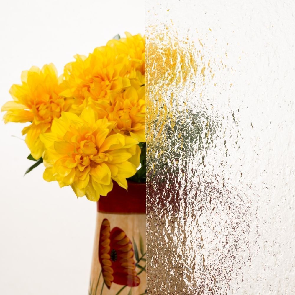 Yellow flowers in a vase, with the right side blurred by a textured distortion