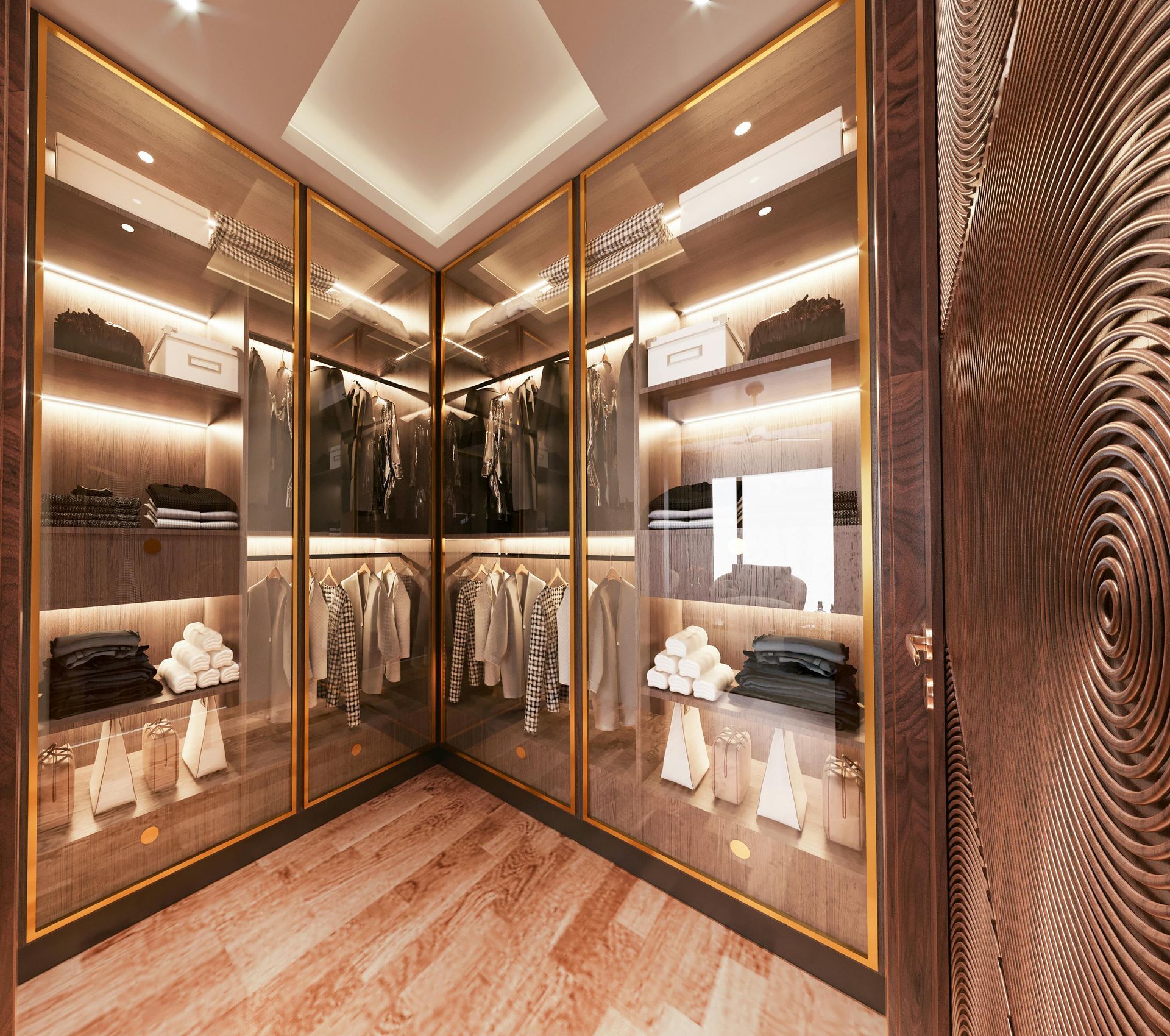 A luxurious walk-in closet with warm wood shelves, glass-fronted cabinets, interior LED lighting, and gold trim accents.