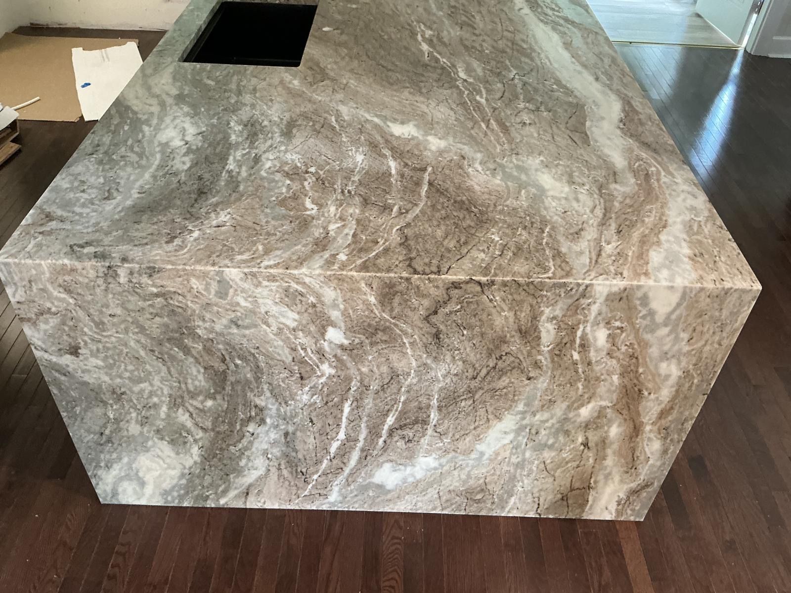 Marble-look decorative box with a square opening on top, sitting indoors on a floor