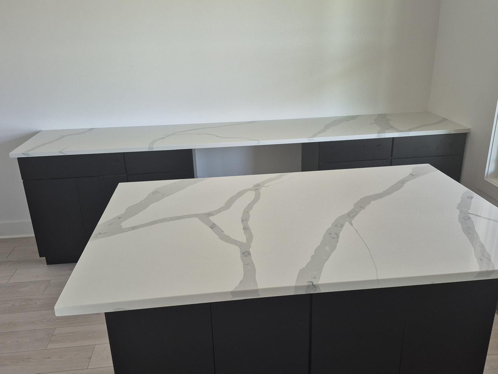 Modern white coffee table in front of a black sideboard against a light wall
