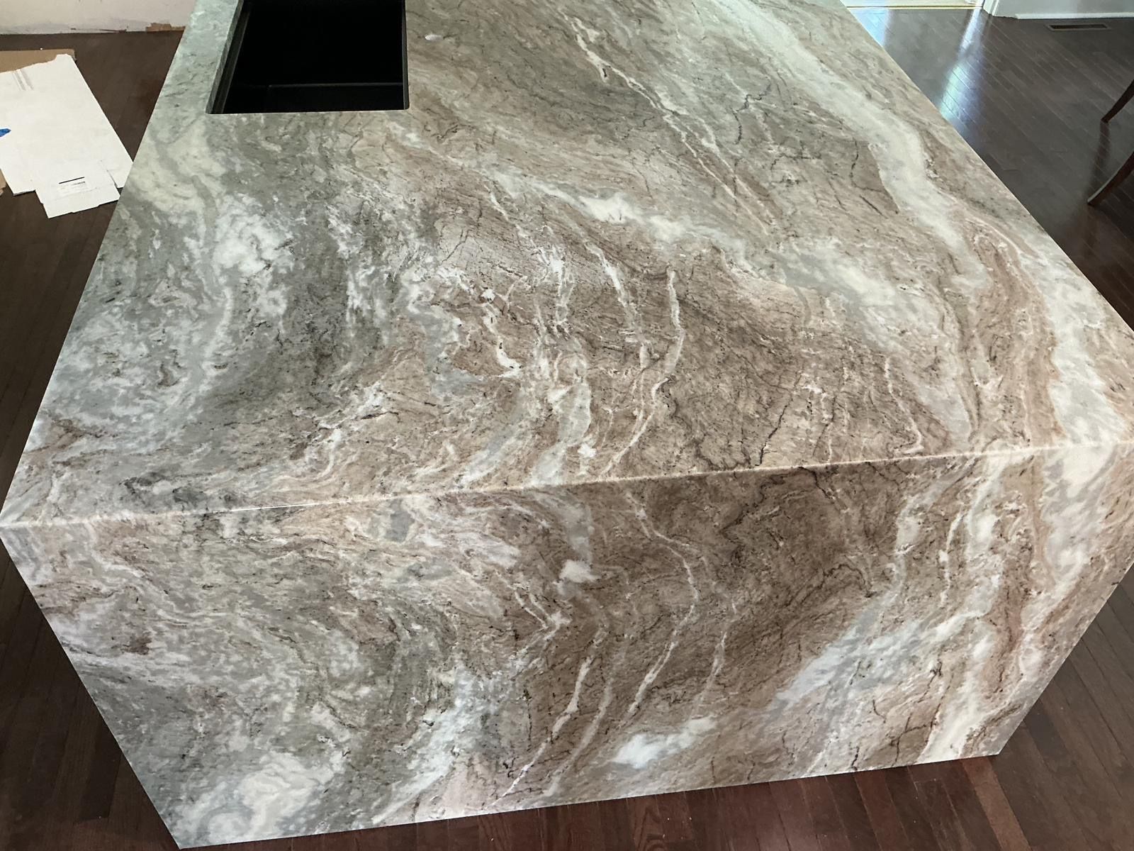 Marble-look rectangular stone pedestal with a black inset opening on top