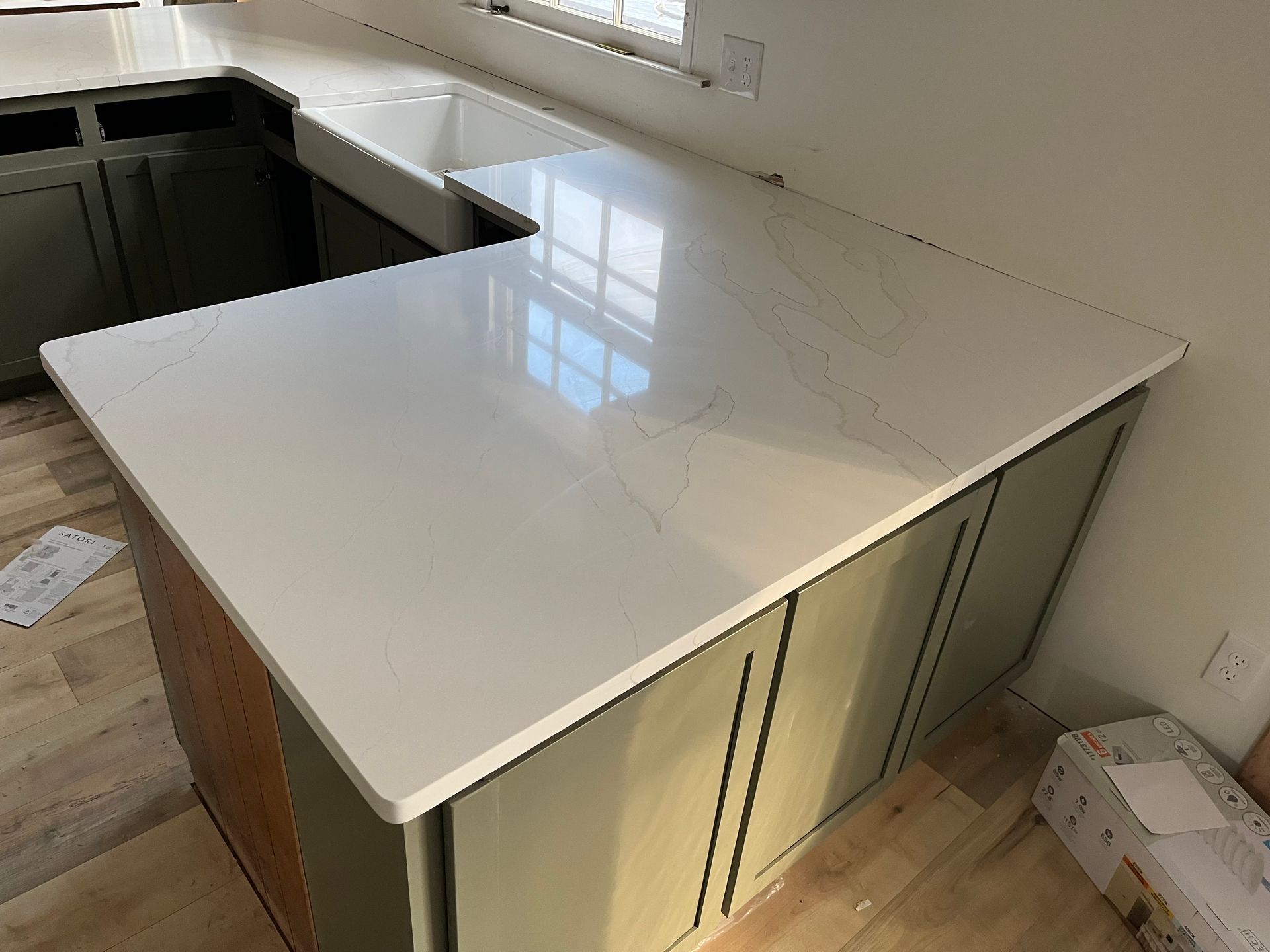 White quartz kitchen island with cabinets in a bright, modern room