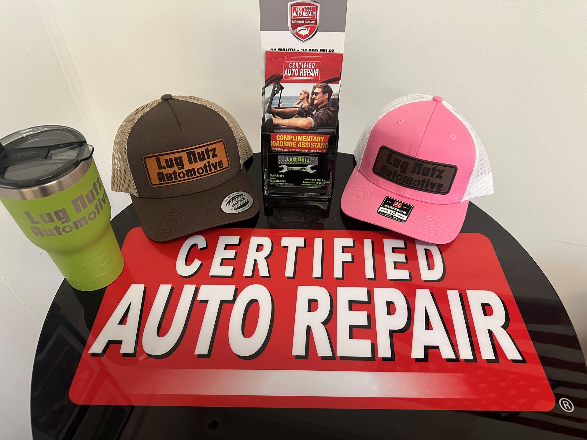 Display of hats, a tumbler, and literature with