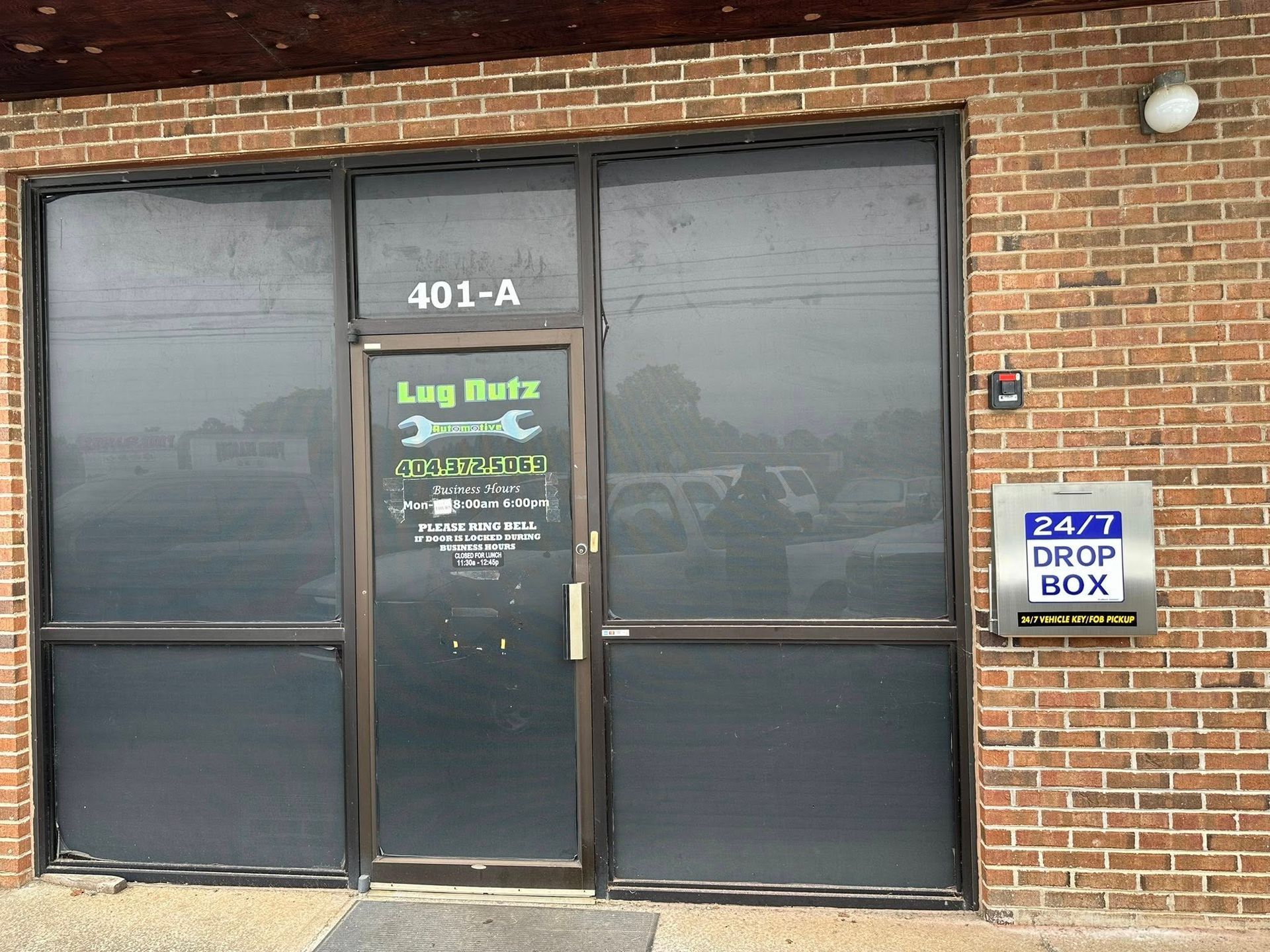 a brick building with a glass door and windows