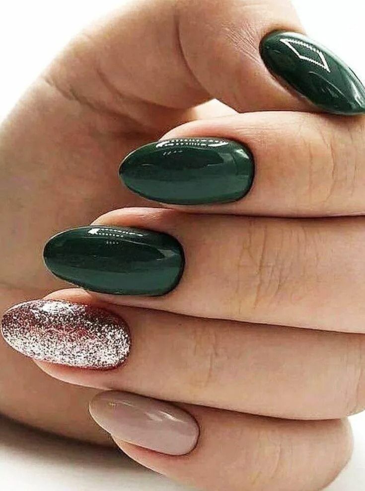 Hand with oval-shaped nails, painted in shades of green, nude, and silver glitter.