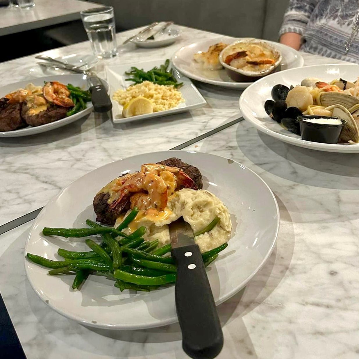 Plates of food on a marble table.