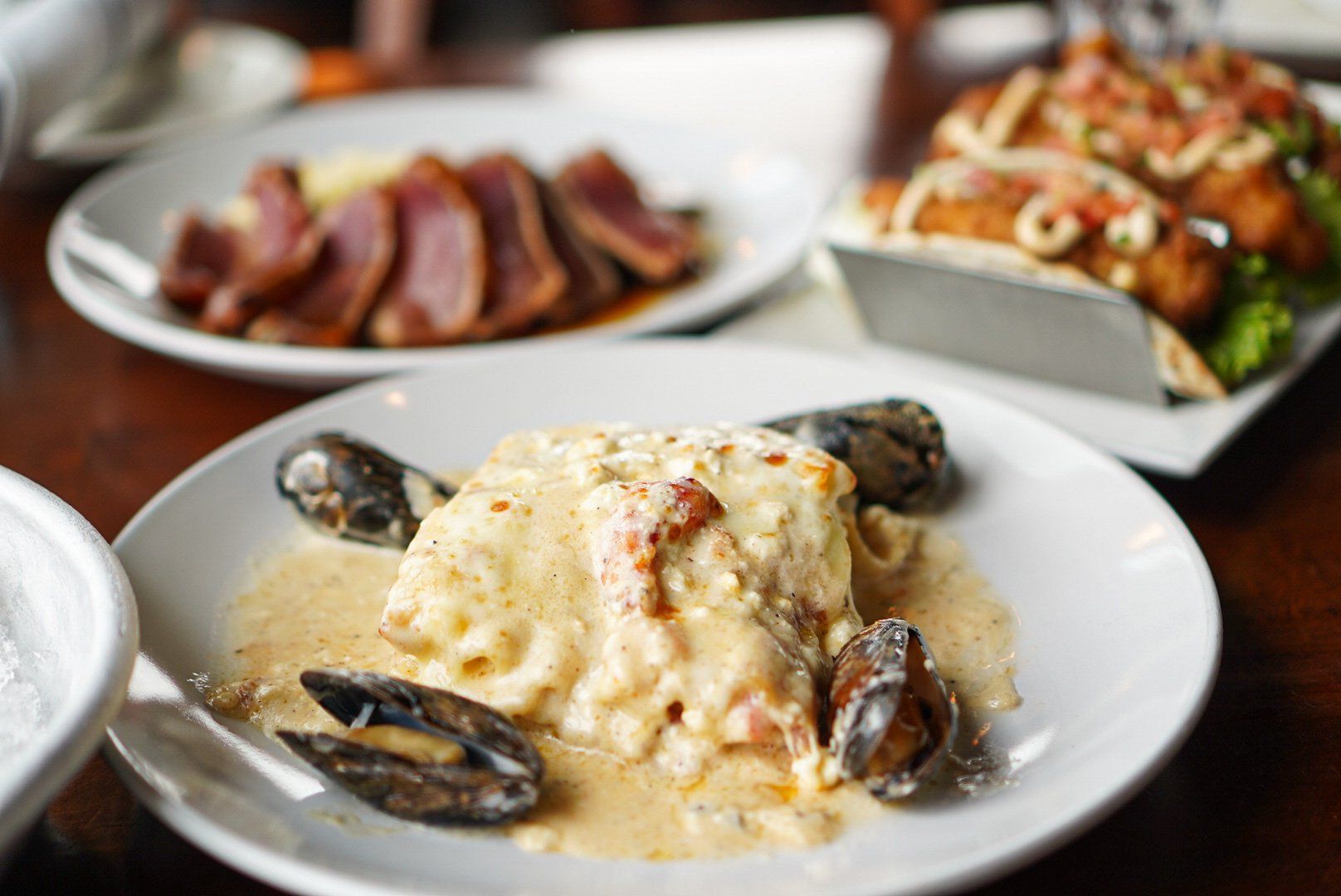 Seared tuna, fish entree with mussels, and tacos.