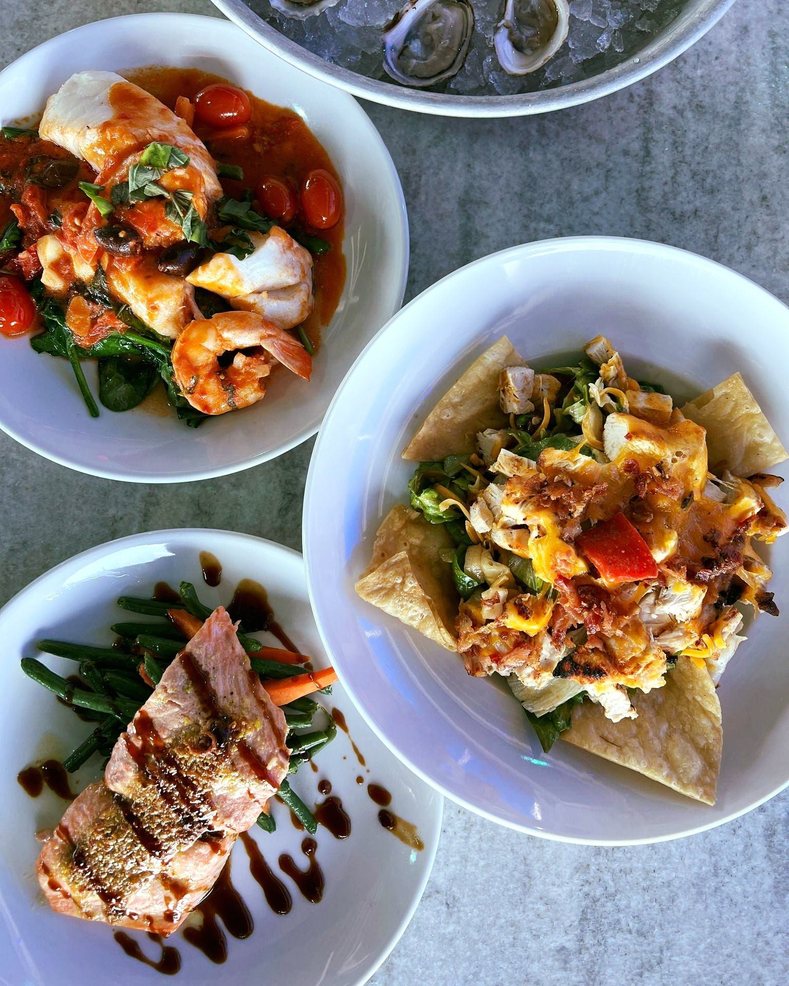 Salmon, shrimp and fish in sauce, and salad.