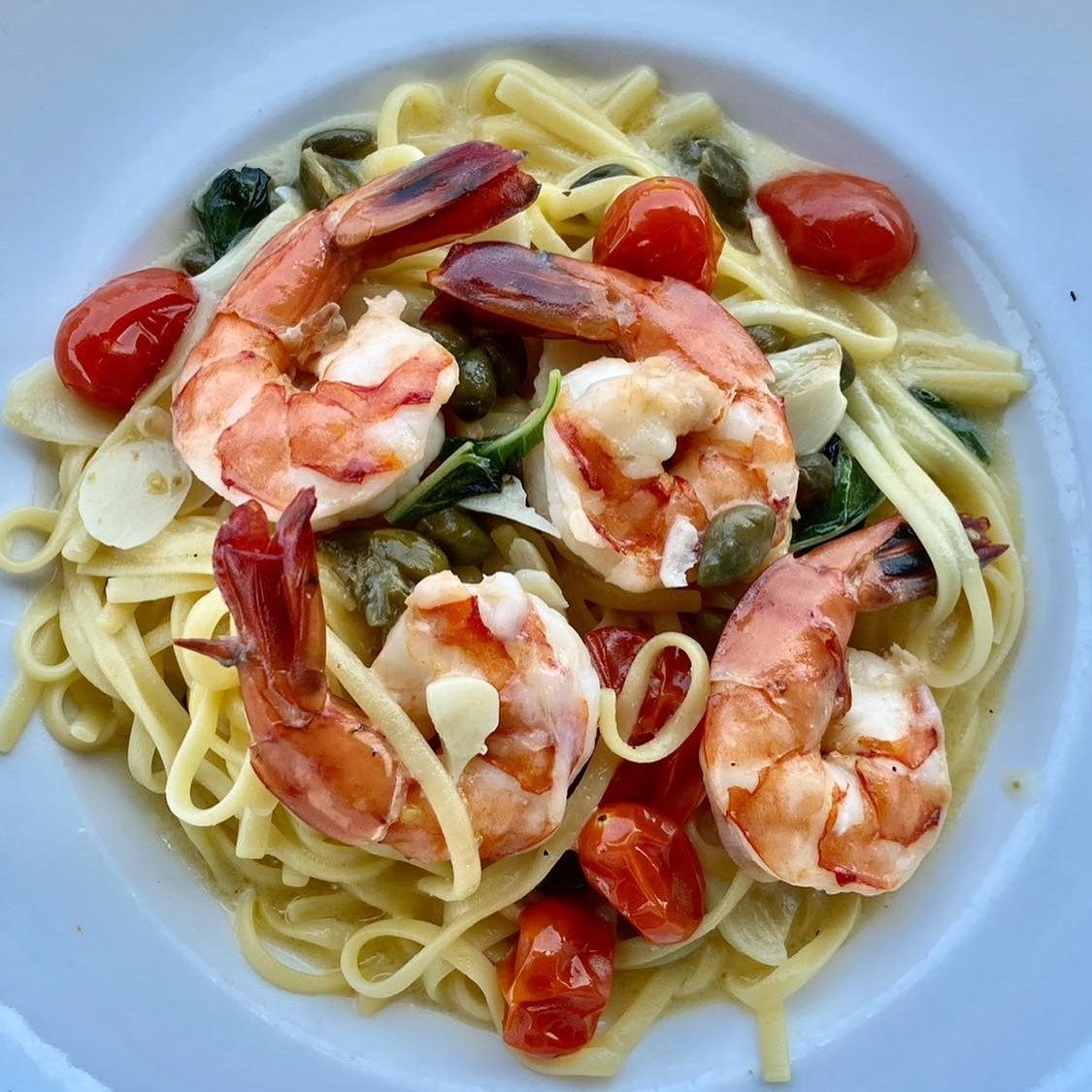Pasta dish with shrimp, tomatoes, capers, and creamy sauce.