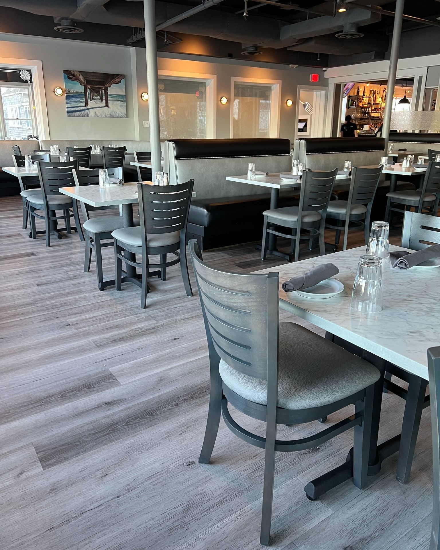 Restaurant interior with tables, chairs, and booths.