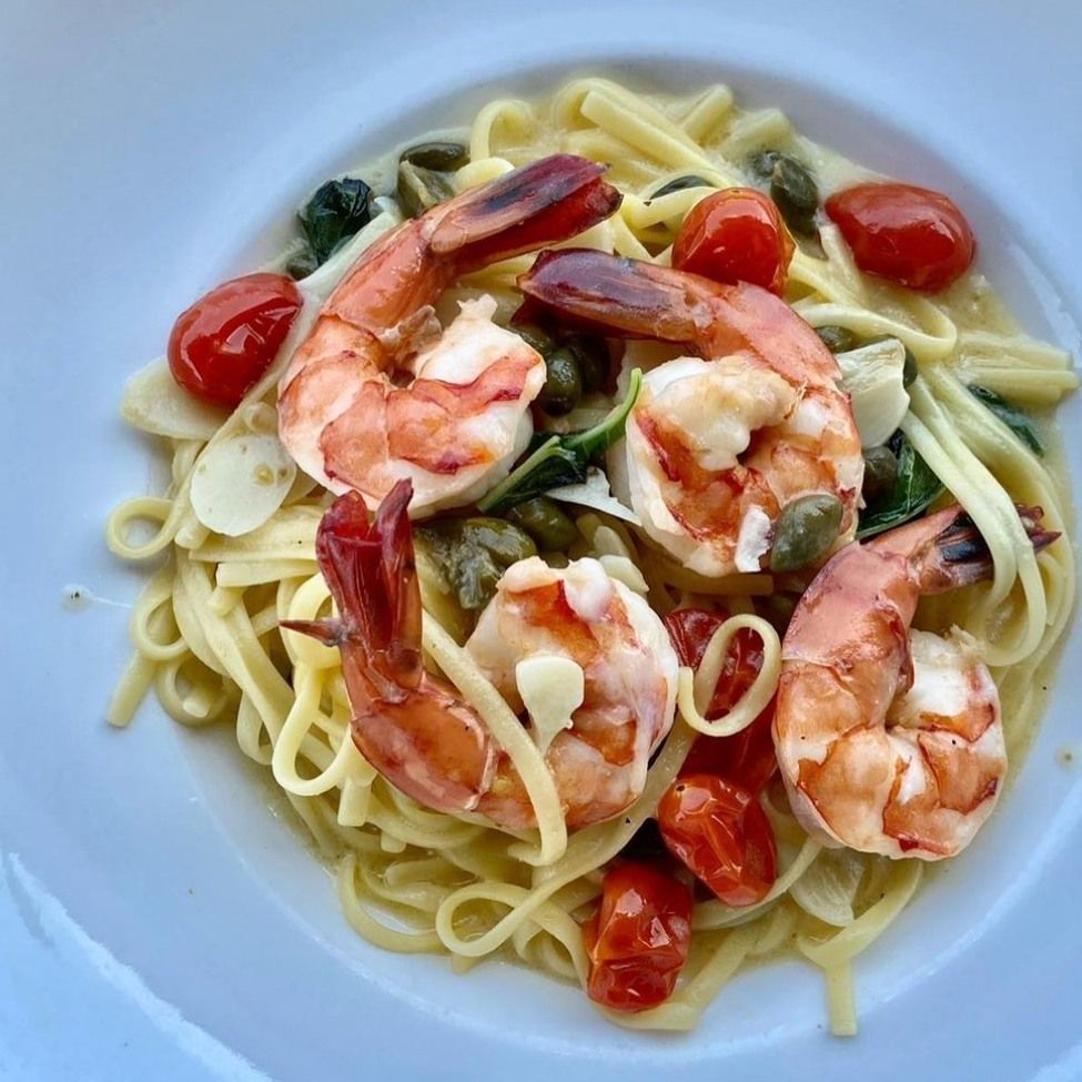 Pasta dish with shrimp, cherry tomatoes, capers, and garlic.