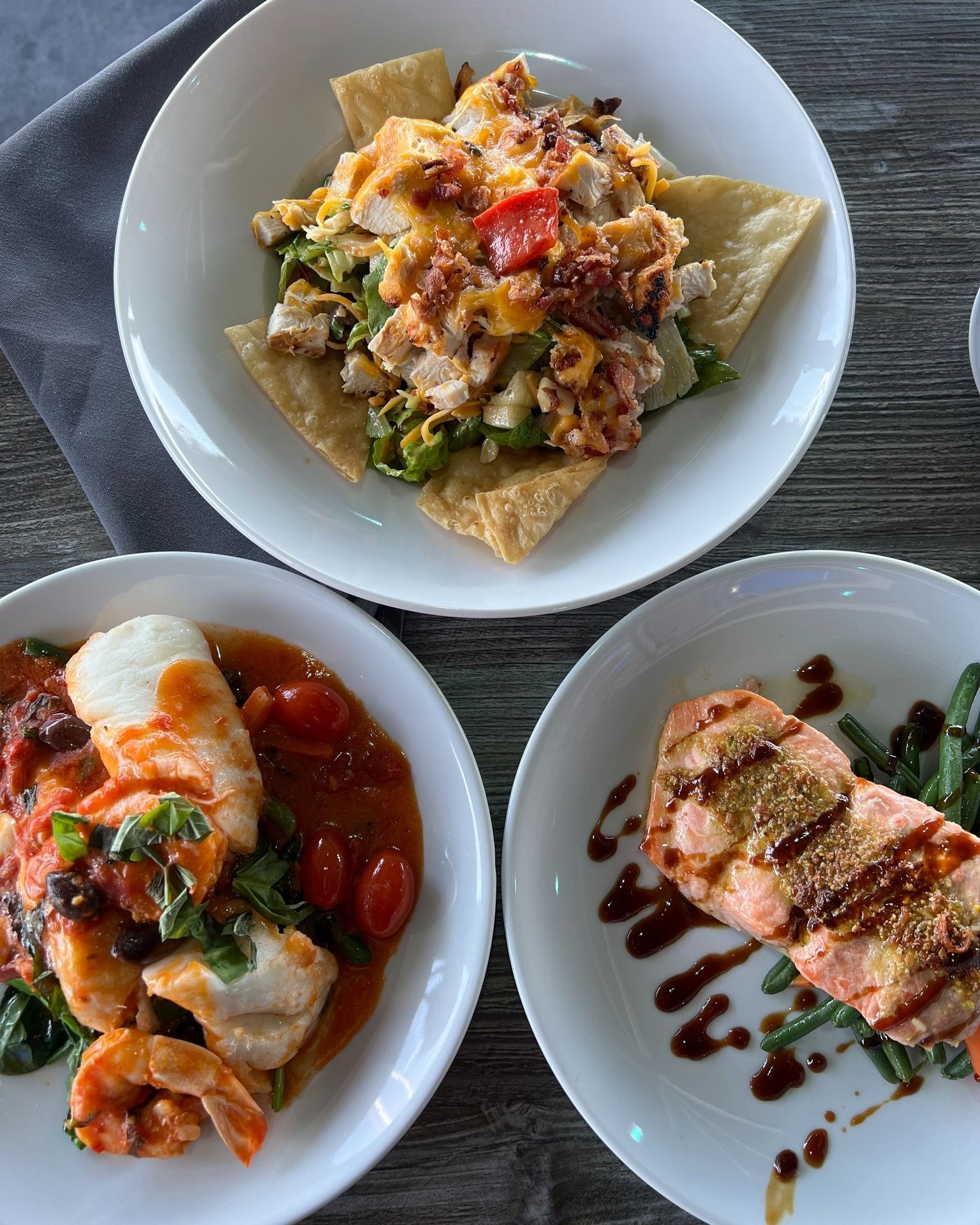 Nachos, fish with tomato sauce, and salmon with green beans.
