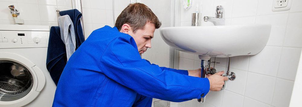 Plumber repairing the sink pipe