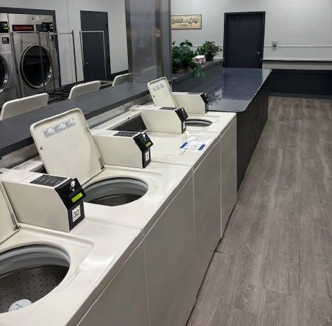 Wicker laundry basket overflowing with colorful clothes: red, pink, blue, and white.