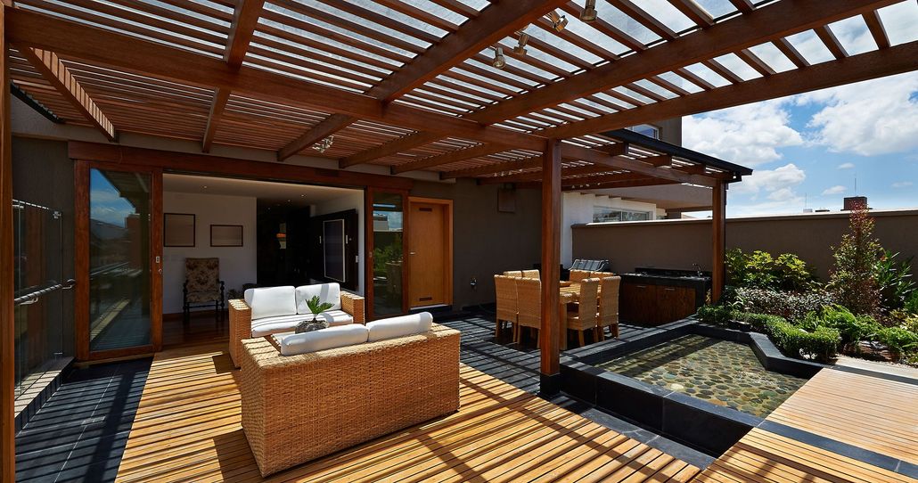 A patio with chairs and a table in front of a house