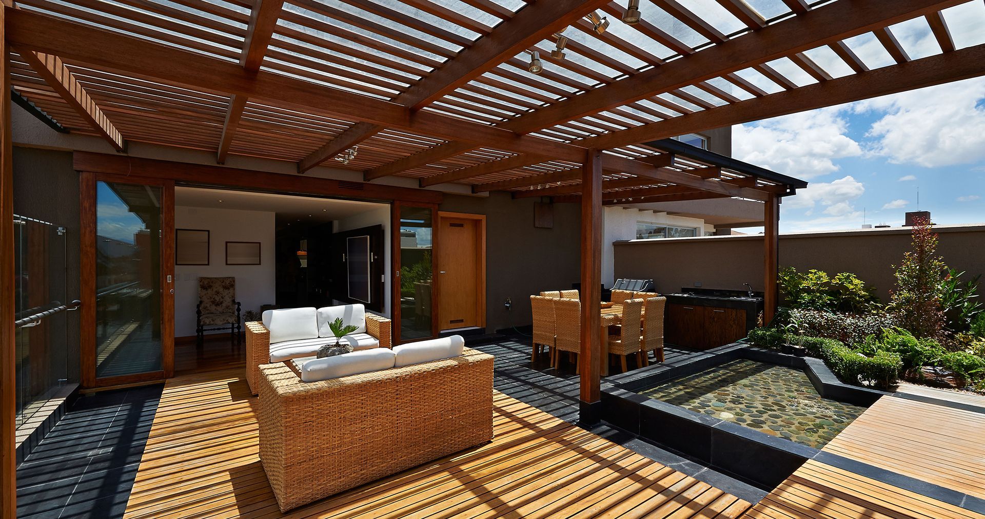 A patio with chairs and a table in front of a house