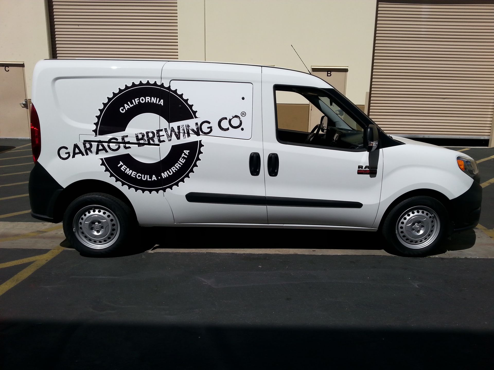 White Garage Brewing Co. delivery van parked outside a building