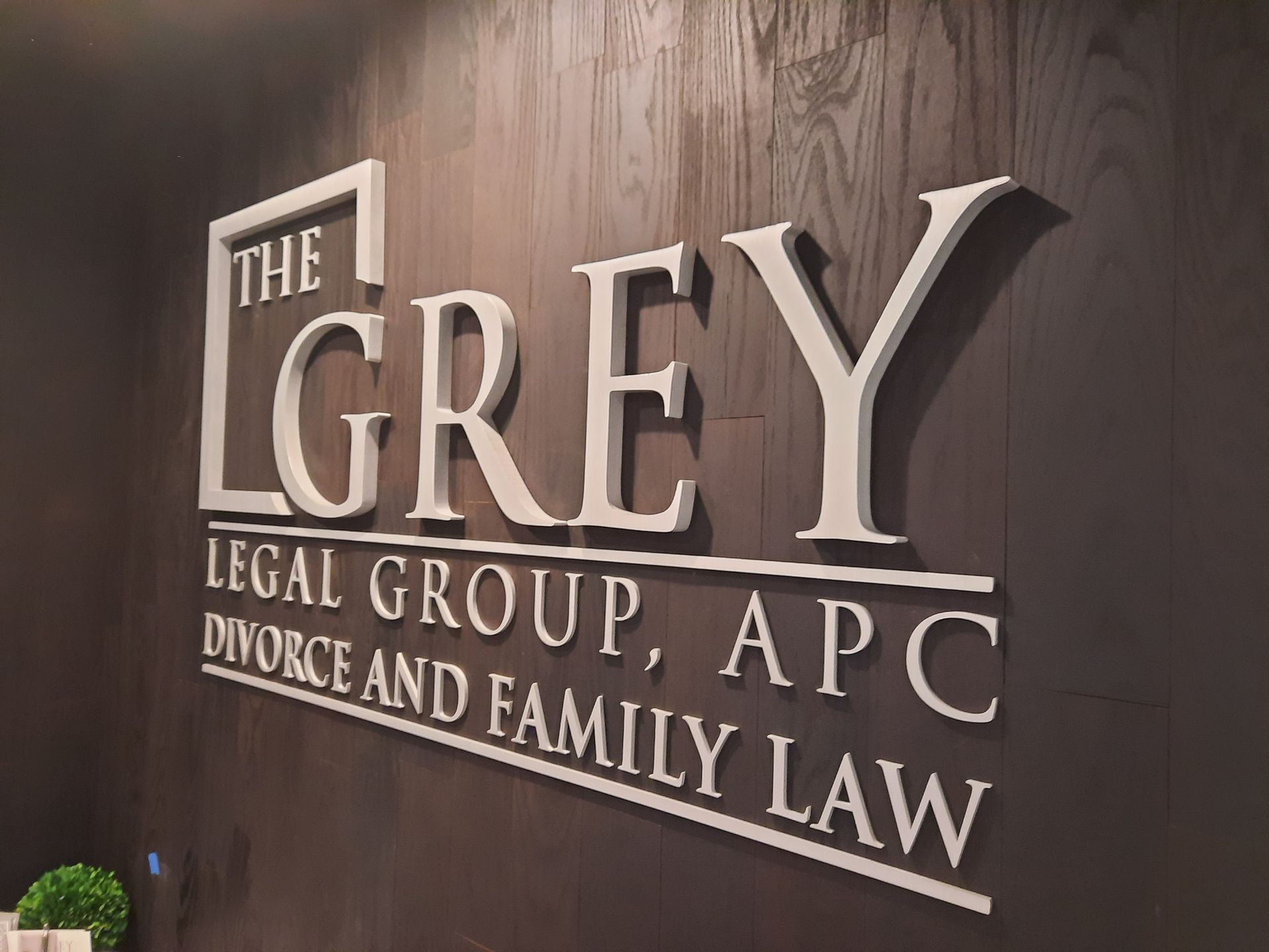 Sign for The Grey Legal Group, APC, Divorce and Family Law on a dark wall