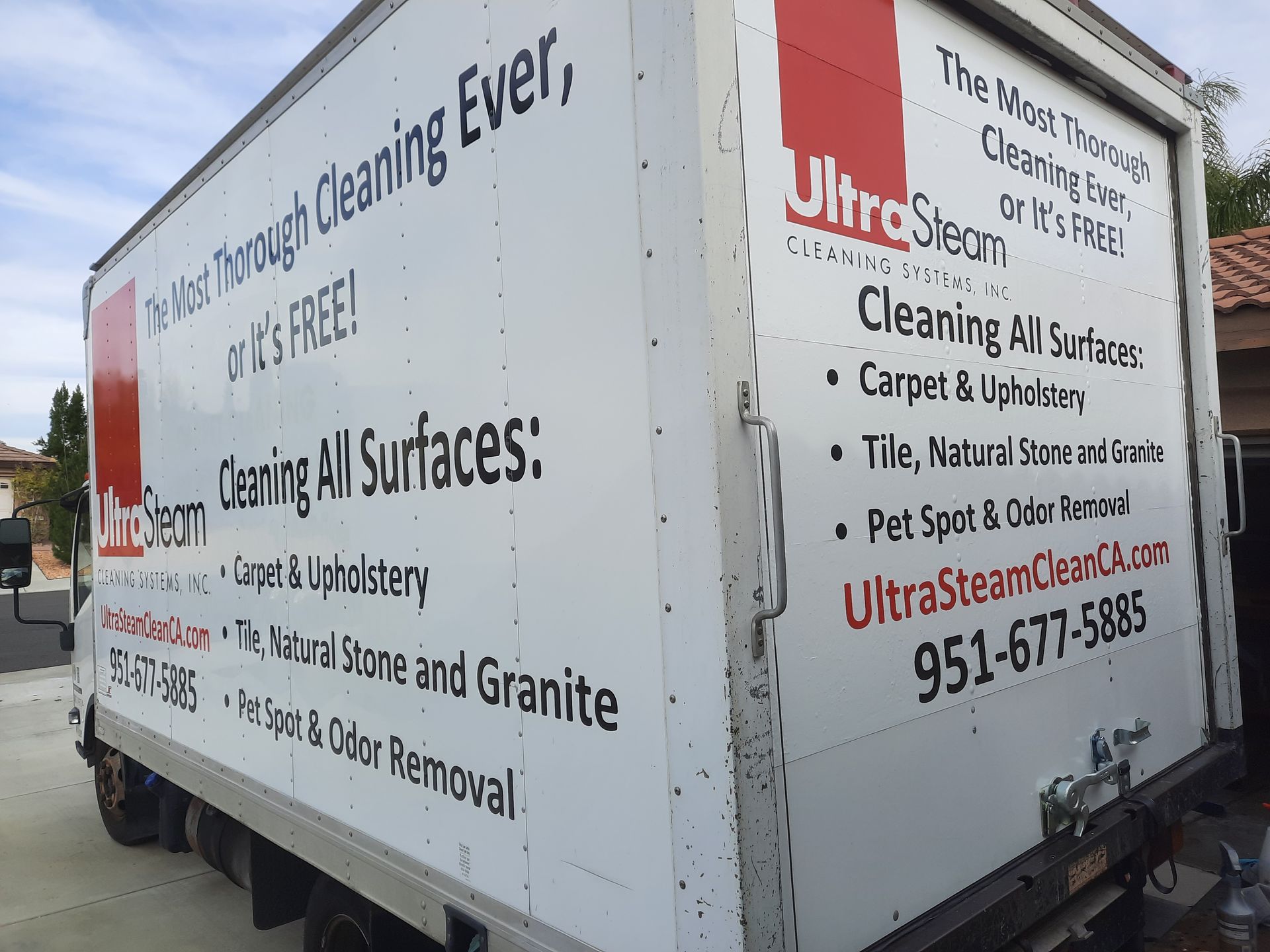 White cleaning service truck with Ultrasteam branding and text listing cleaning services.