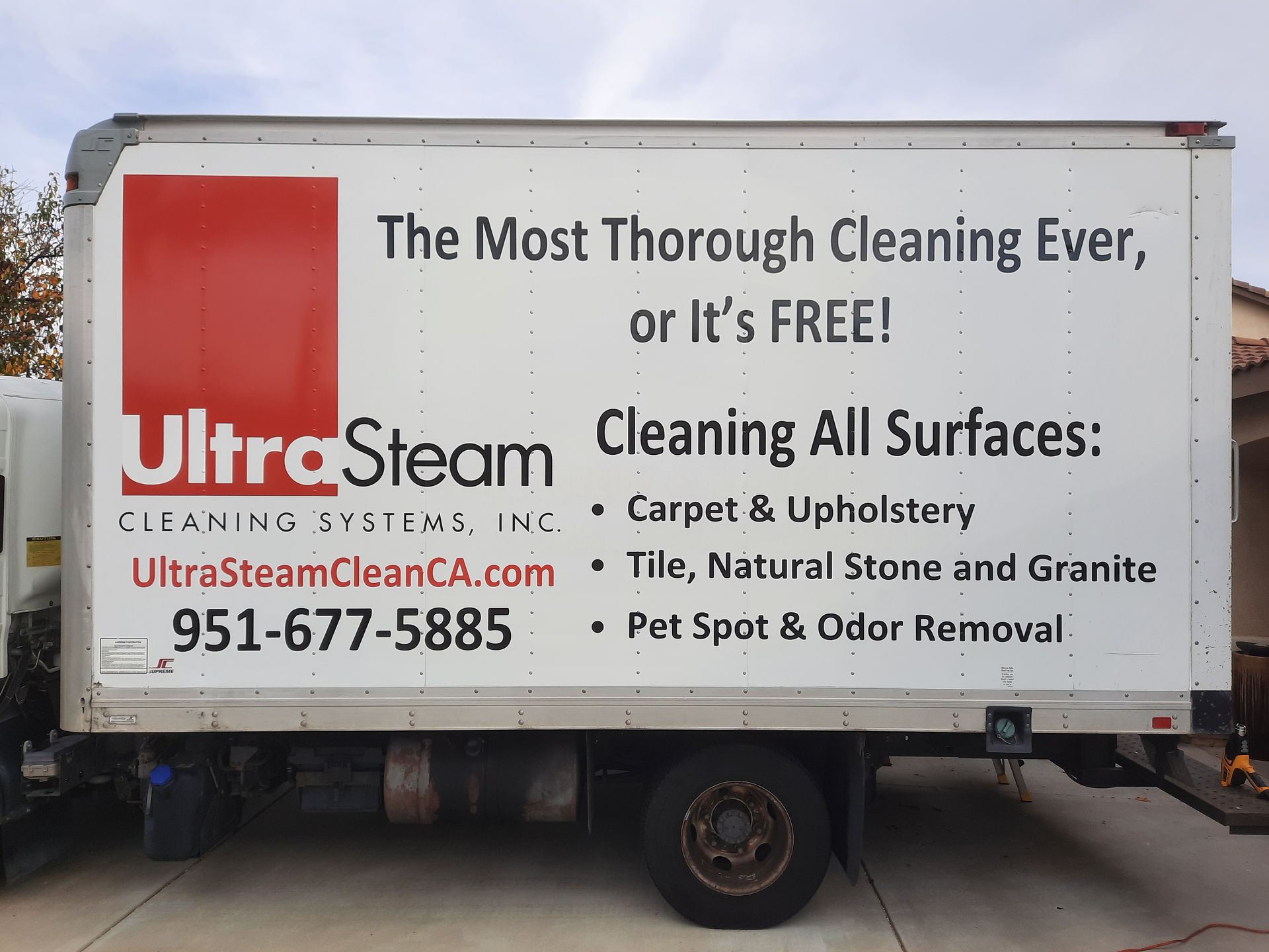 Ultrasteam cleaning truck with red logo and services listed on white side panel