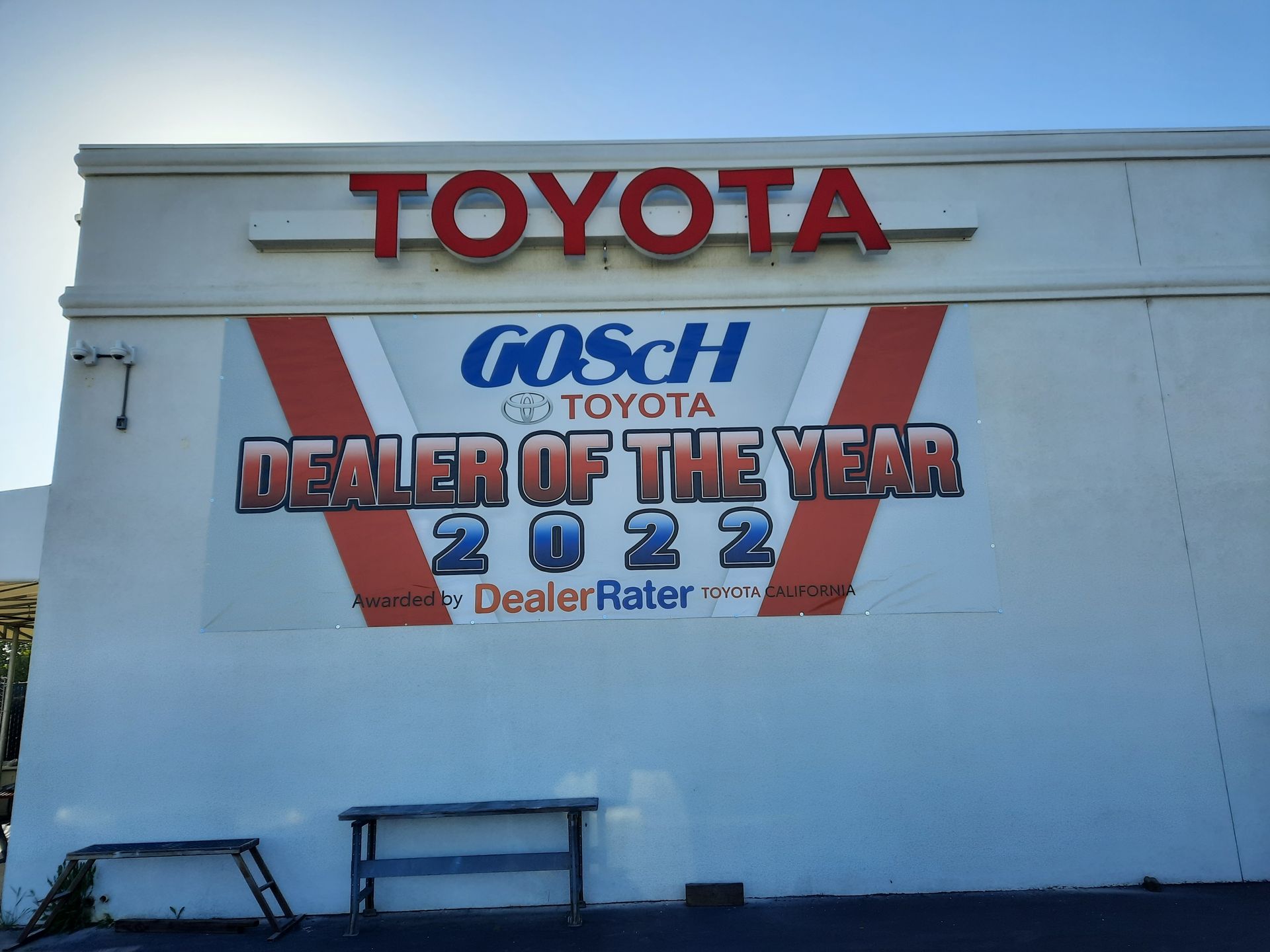 Toyota dealership wall sign for Bosch Toyota Dealer of the Year 2022, red and blue on white building