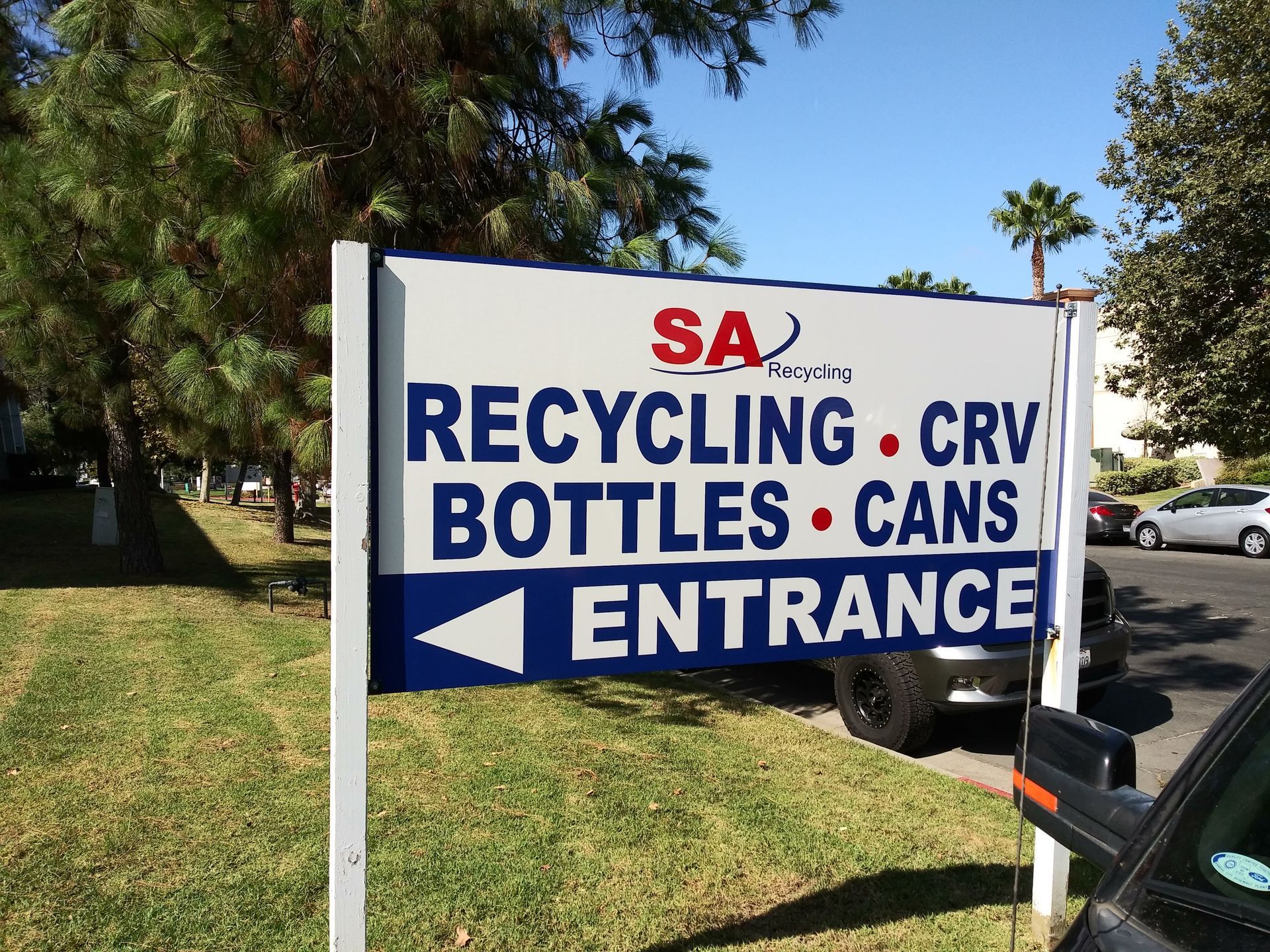 SA recycling sign with arrows for bottles and cans entrance outdoors