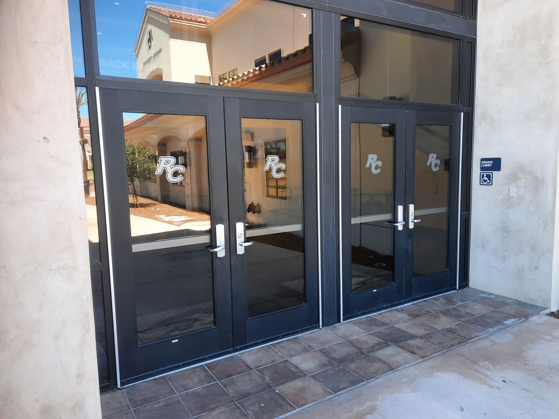 Glass double doors with dark frames at a building entrance