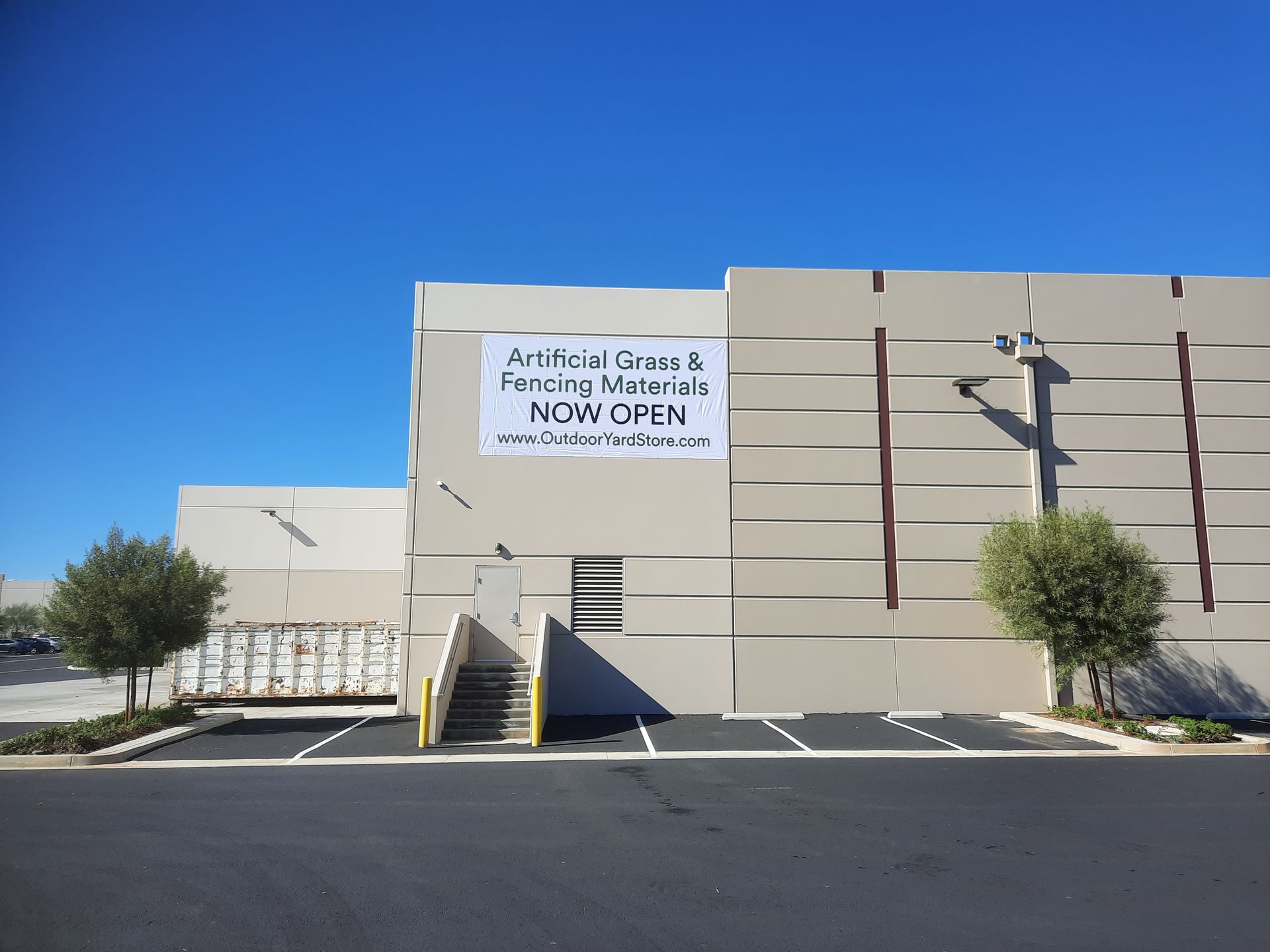 Artistic Glass & Picture Framing storefront with beige facade and blue sky, marked “Now Open.”