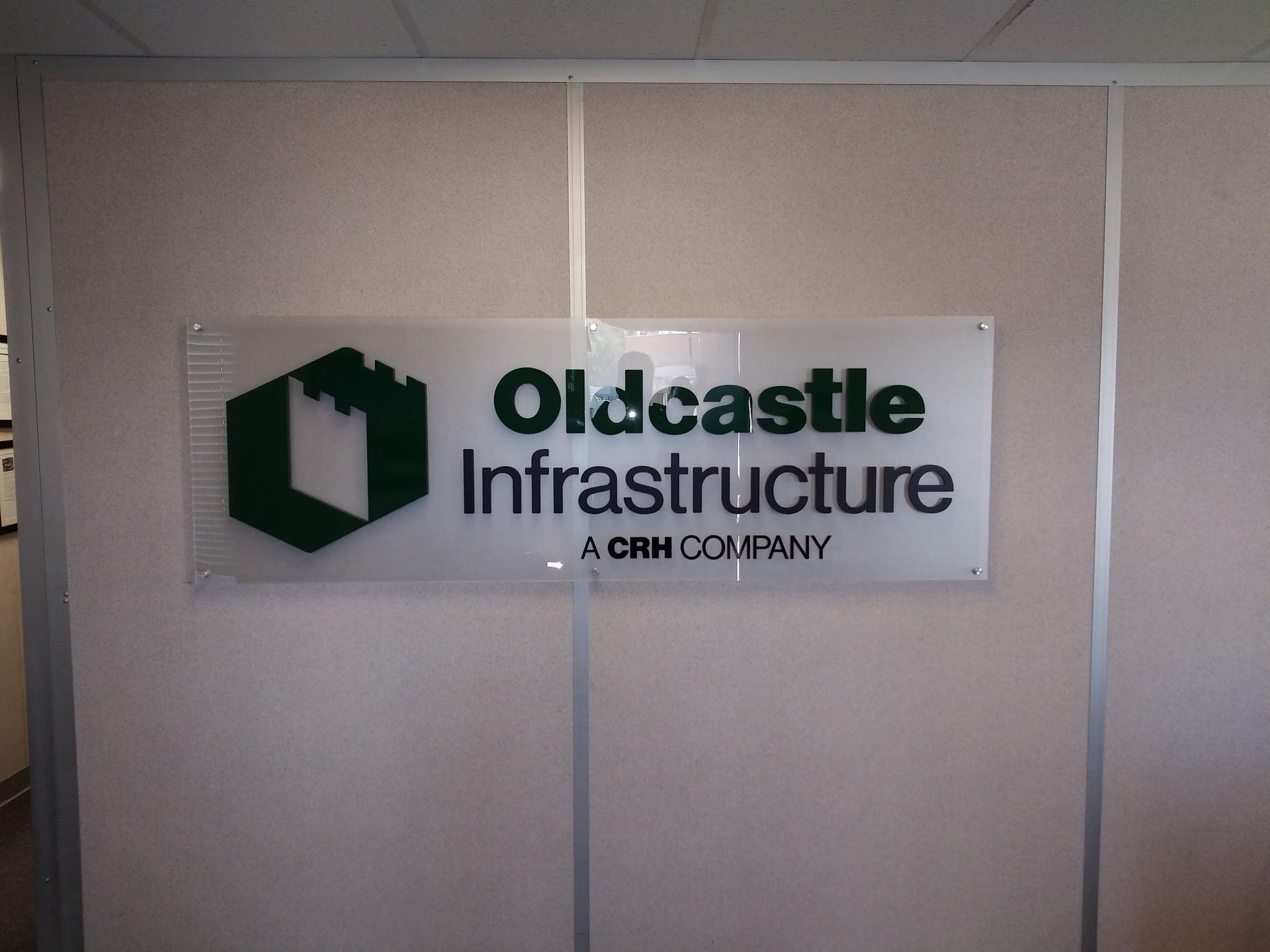 Oldcastle Infrastructure logo sign on a beige office wall