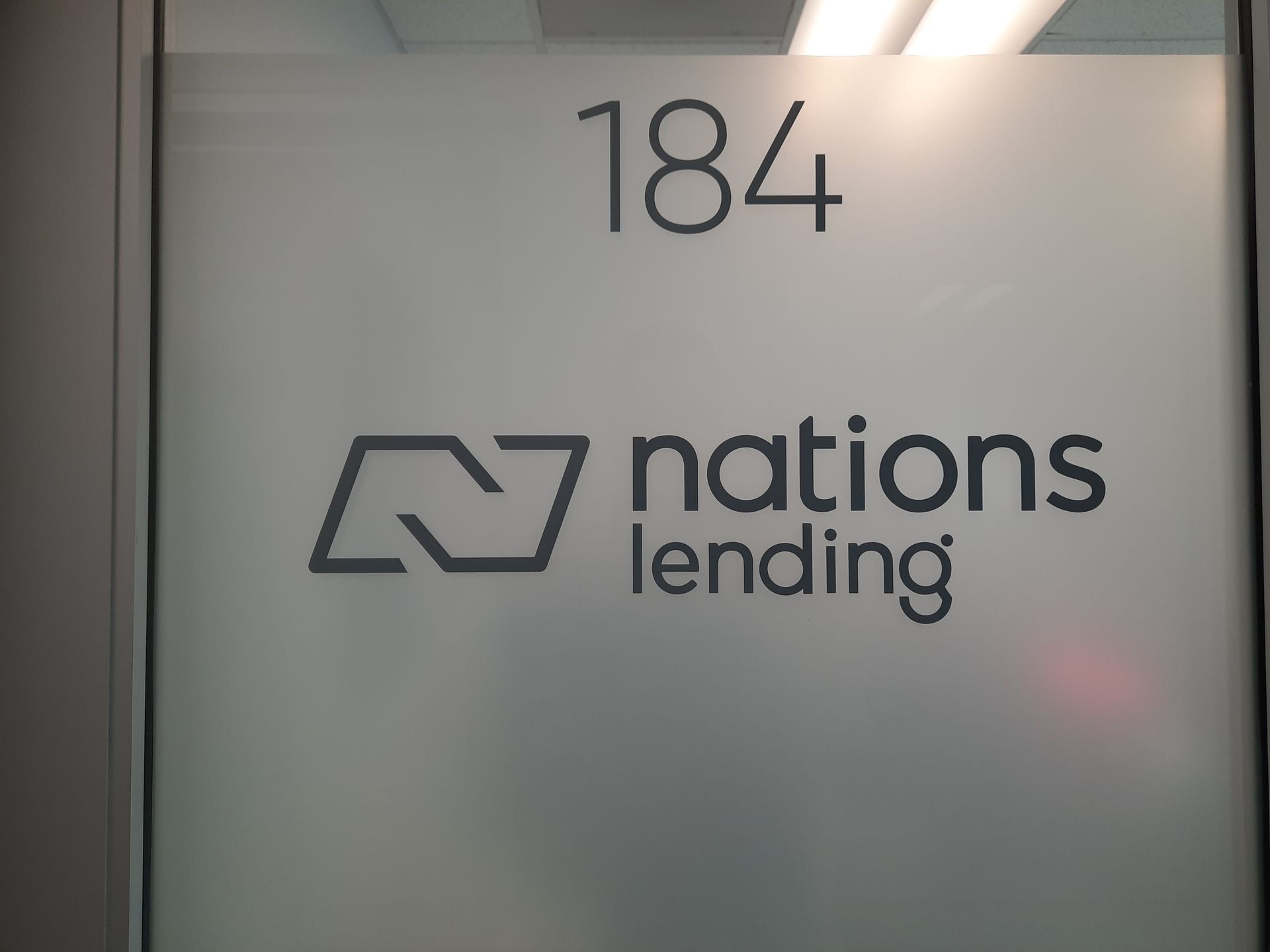 Office door labeled “184” with the Nations Lending logo and name on a frosted glass panel