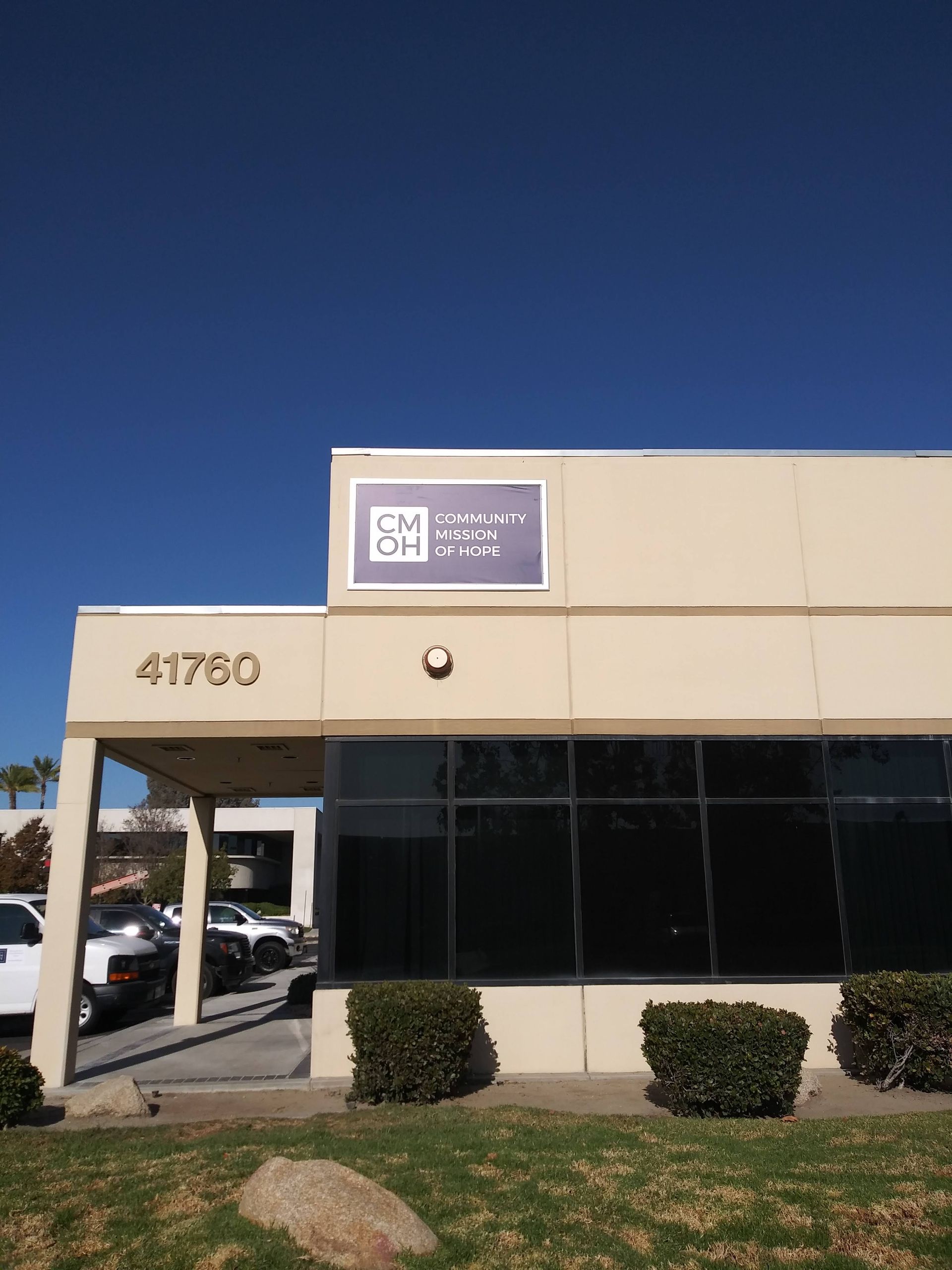 Cream-and-black office building with a blue sign and the number 41760 above the entrance.