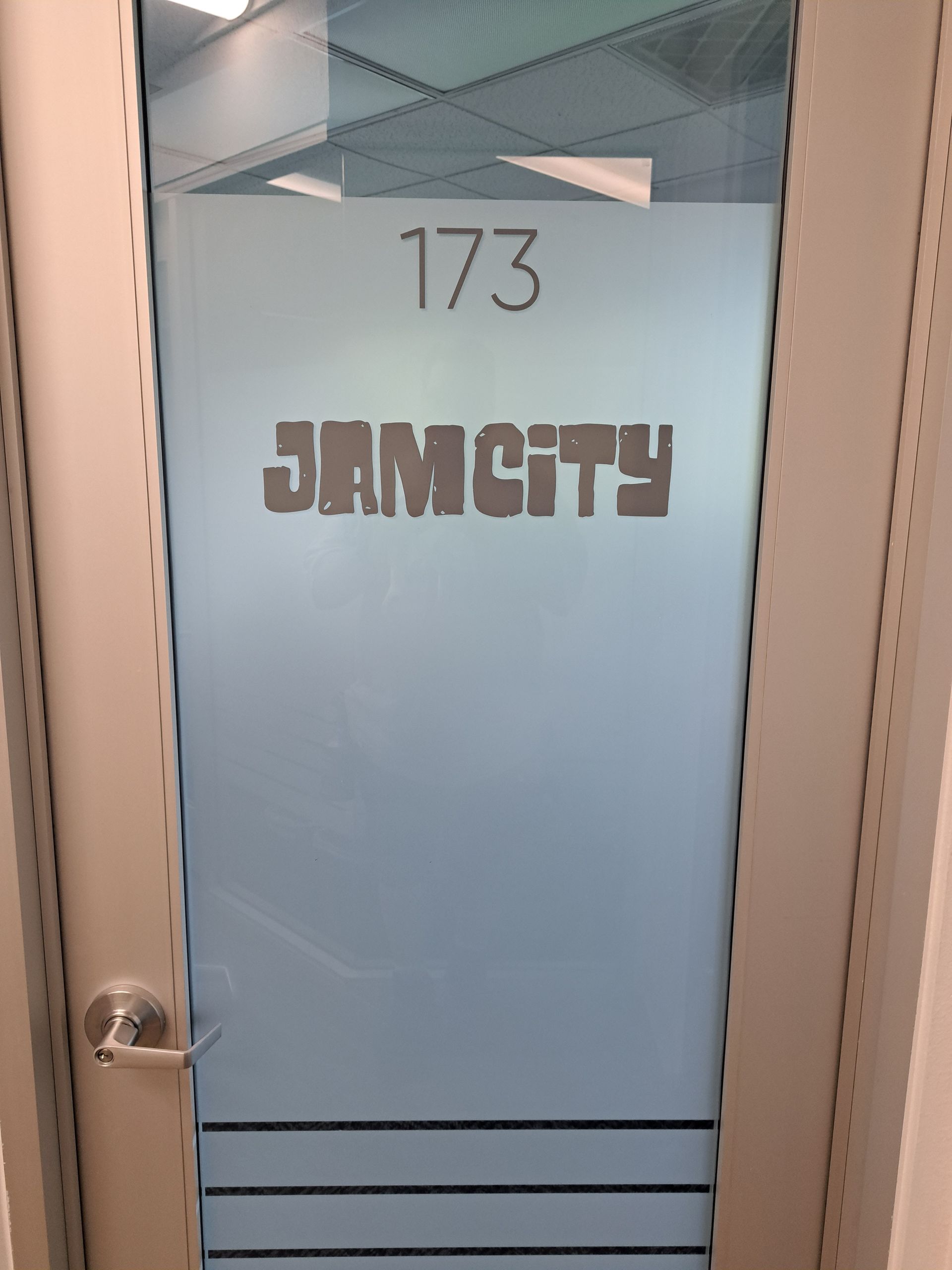 Blue door marked “173” and “JAMCITY” in a hallway.