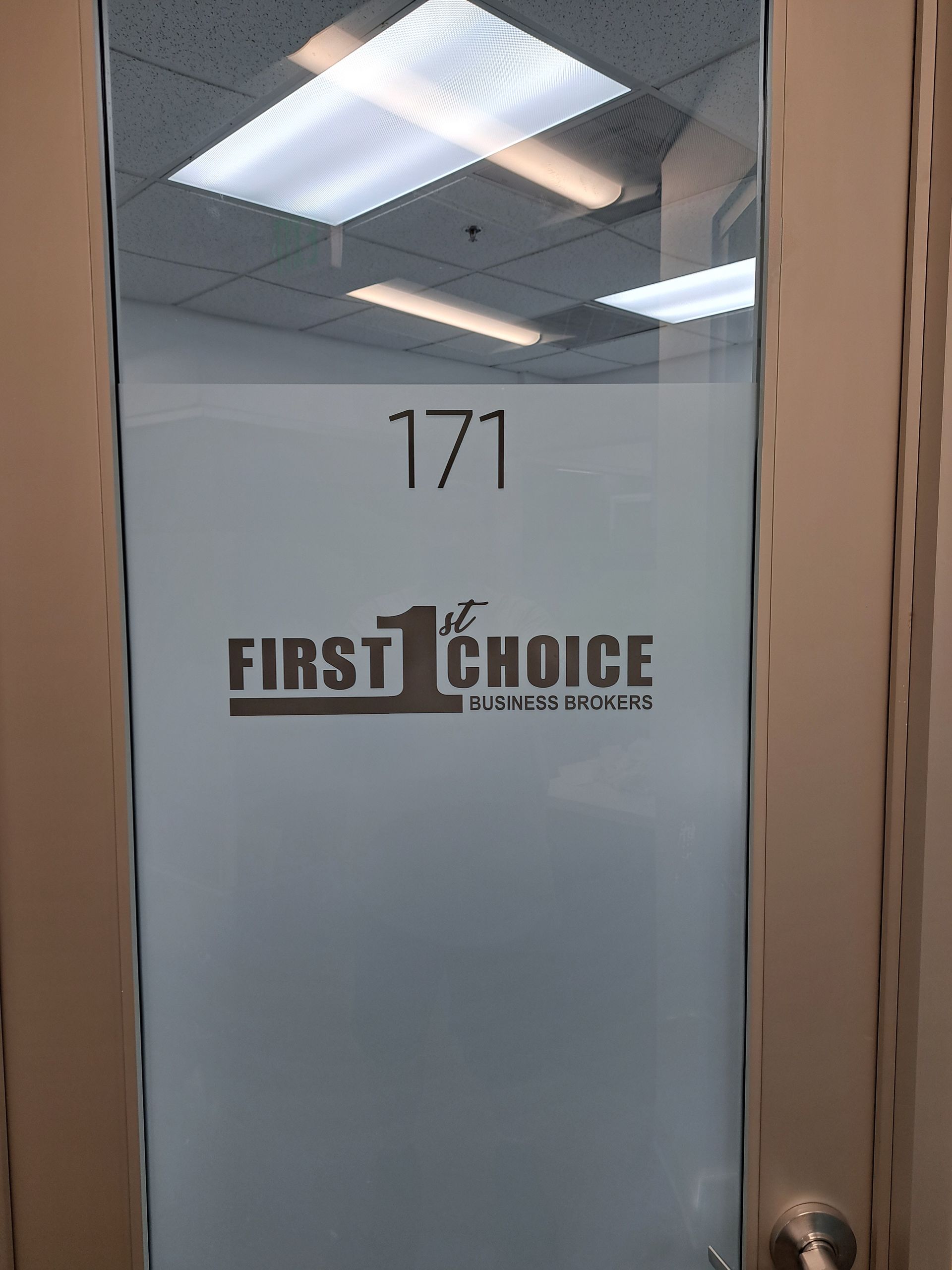 Glass office door labeled “171” with First Choice logo and frosted panel outside a hallway