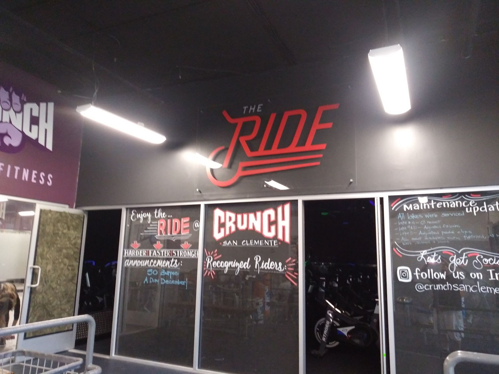 Gym entrance with The Ride sign, Crunch Fitness branding, and lit interior doors
