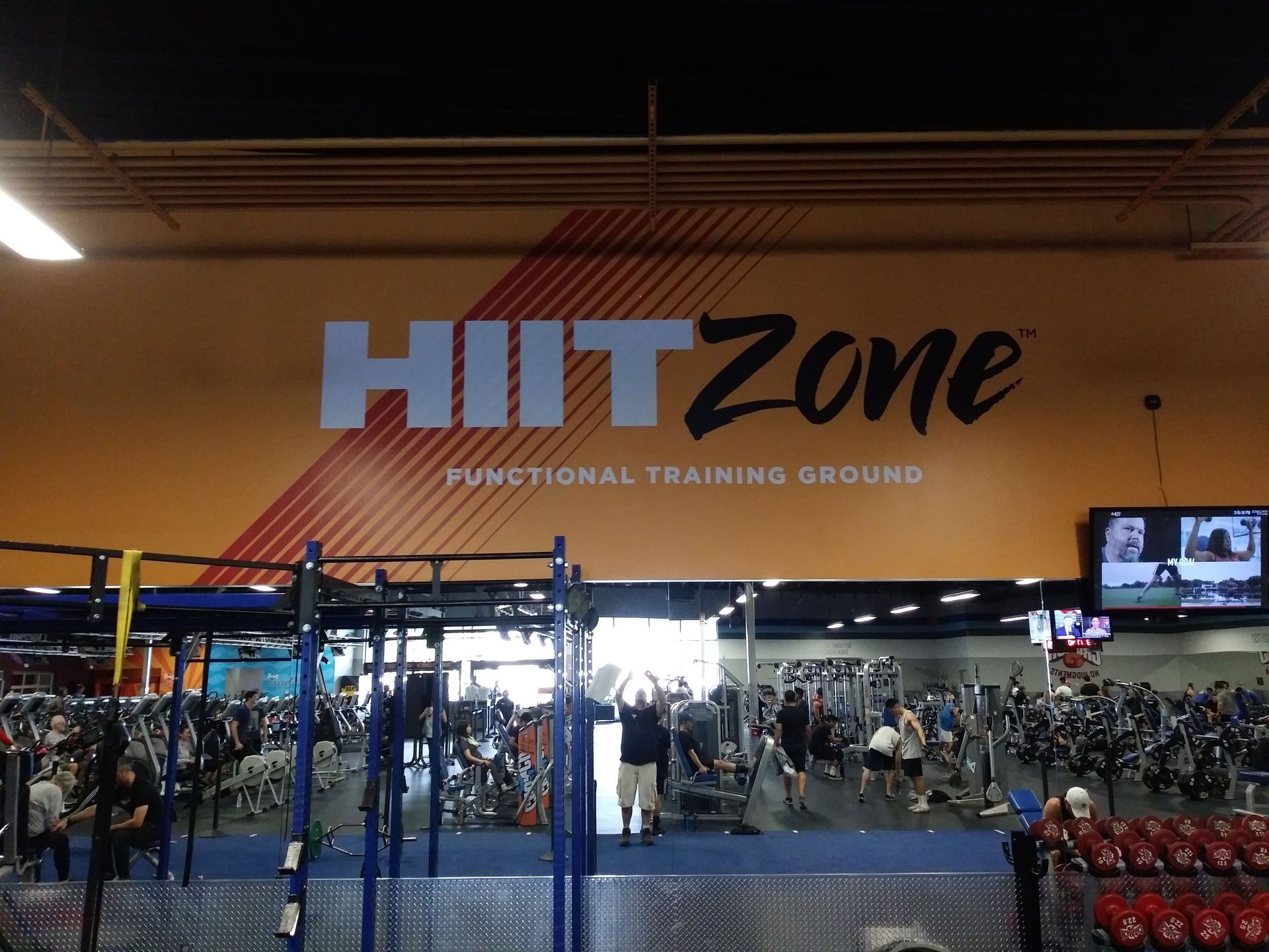 HIITZone functional training gym with workout rigs and people exercising inside a large indoor space