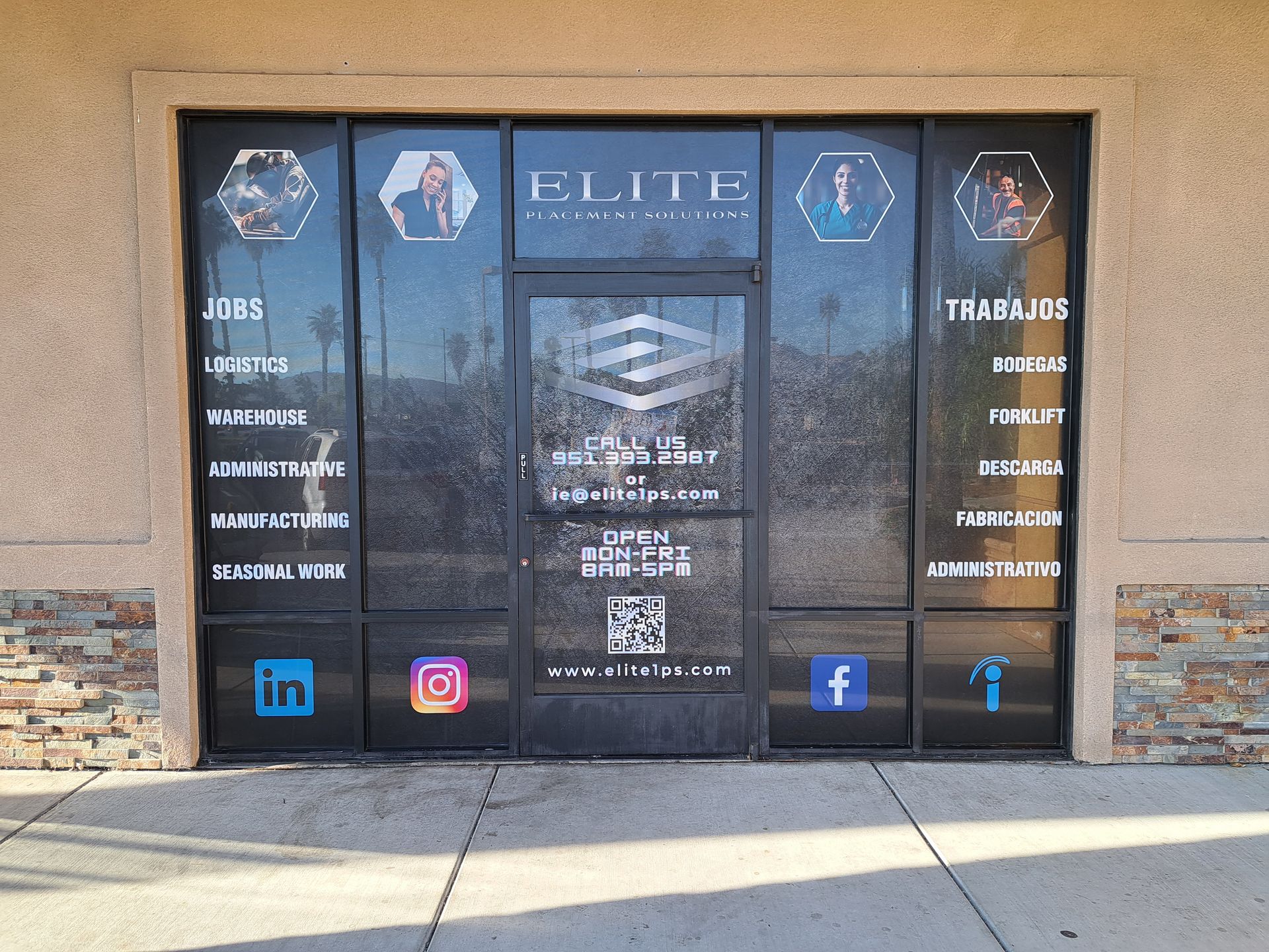 Glass storefront with ELITE salon signage, service list, and social media icons on the windows