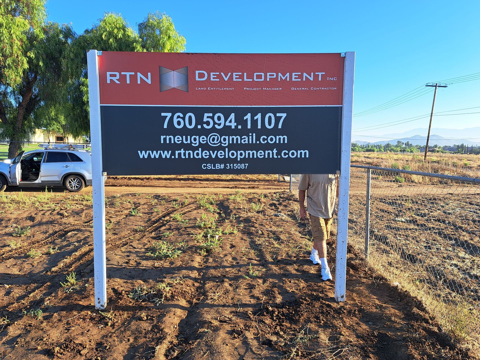 RTN Development roadside sign in a dry field, with phone number and website