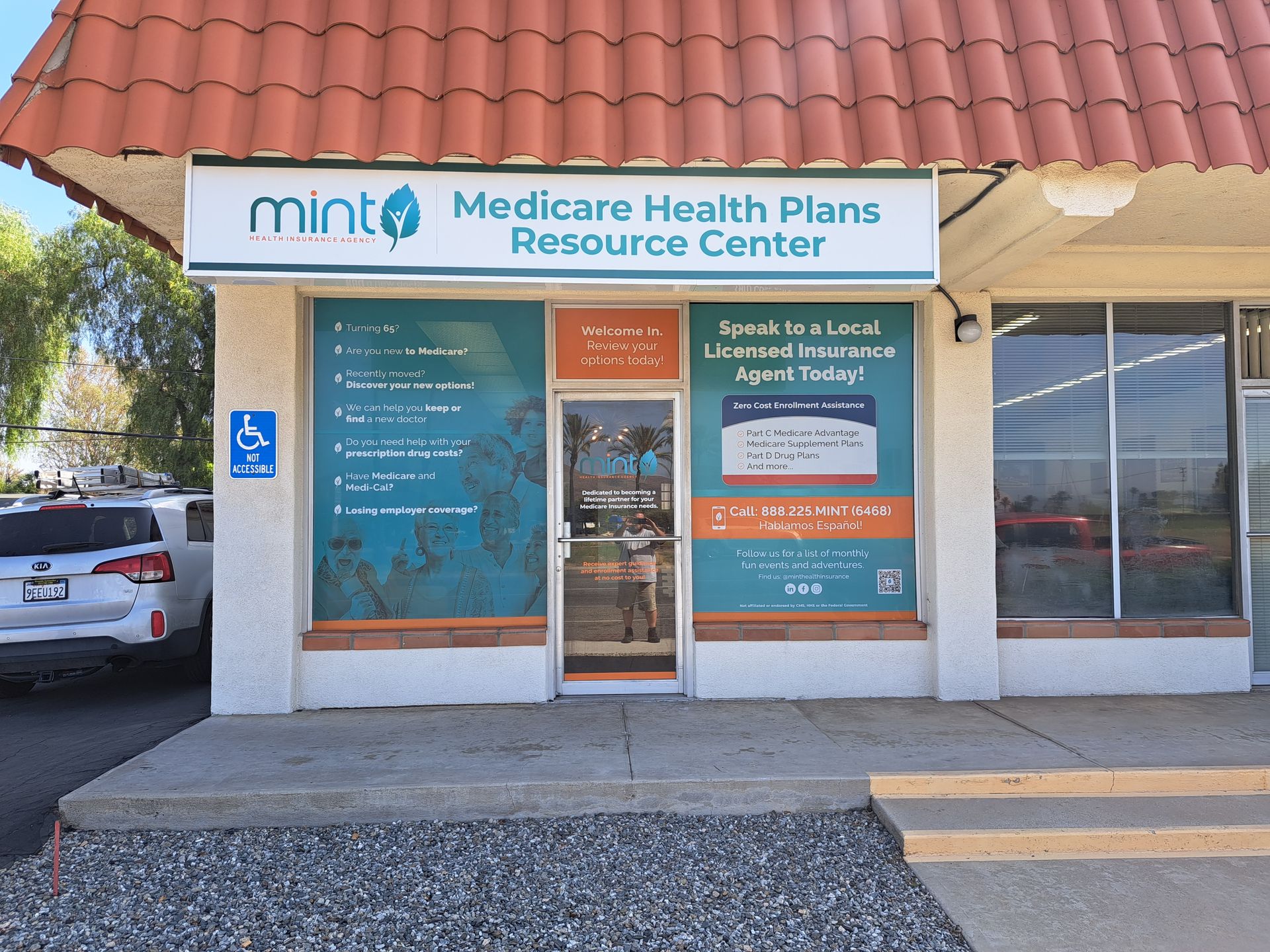 Mint Medicine Health Plans Resource Center storefront with blue and orange signage and glass entrance