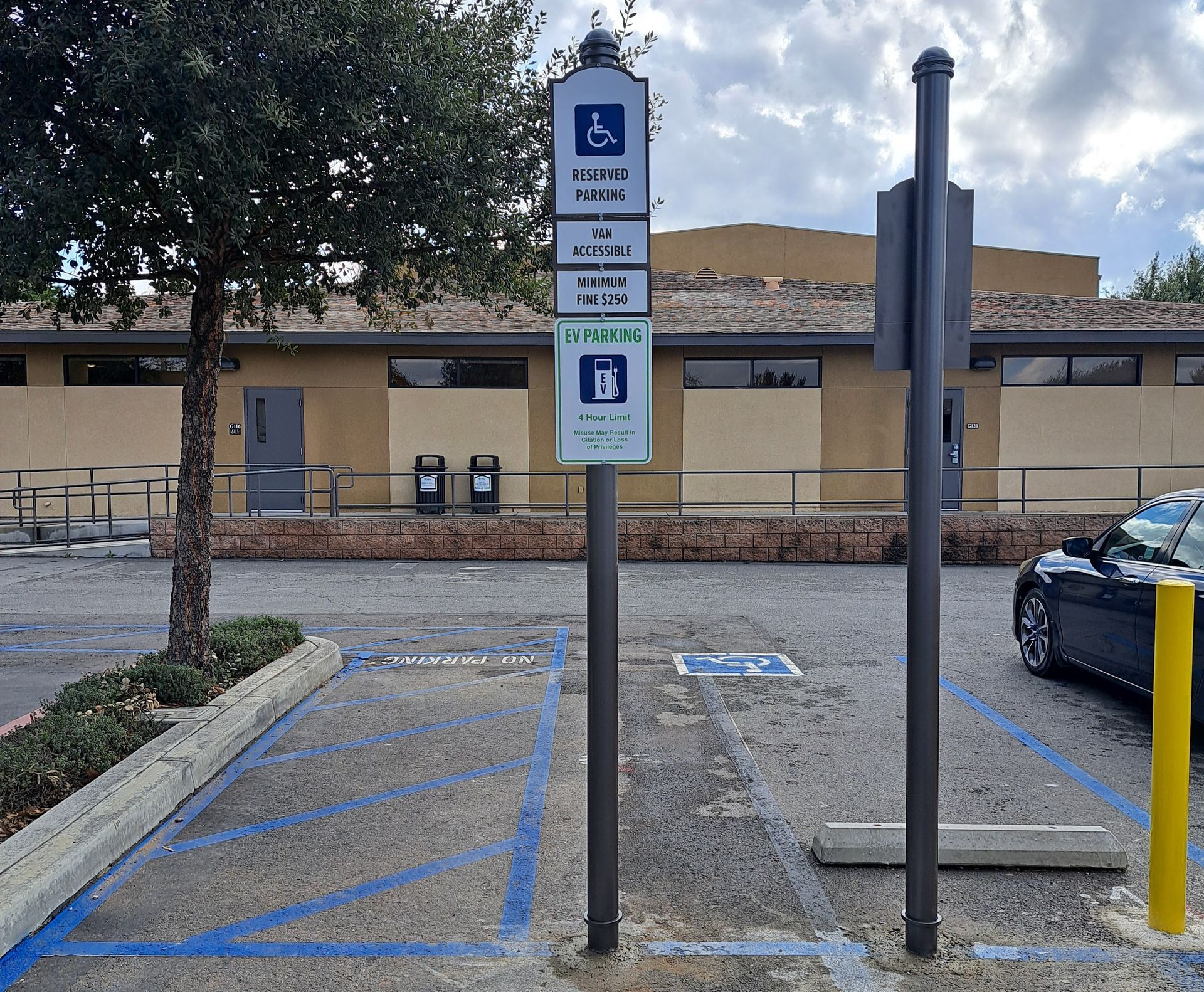 Accessible parking spaces with blue markings and a wheelchair sign in a parking lot