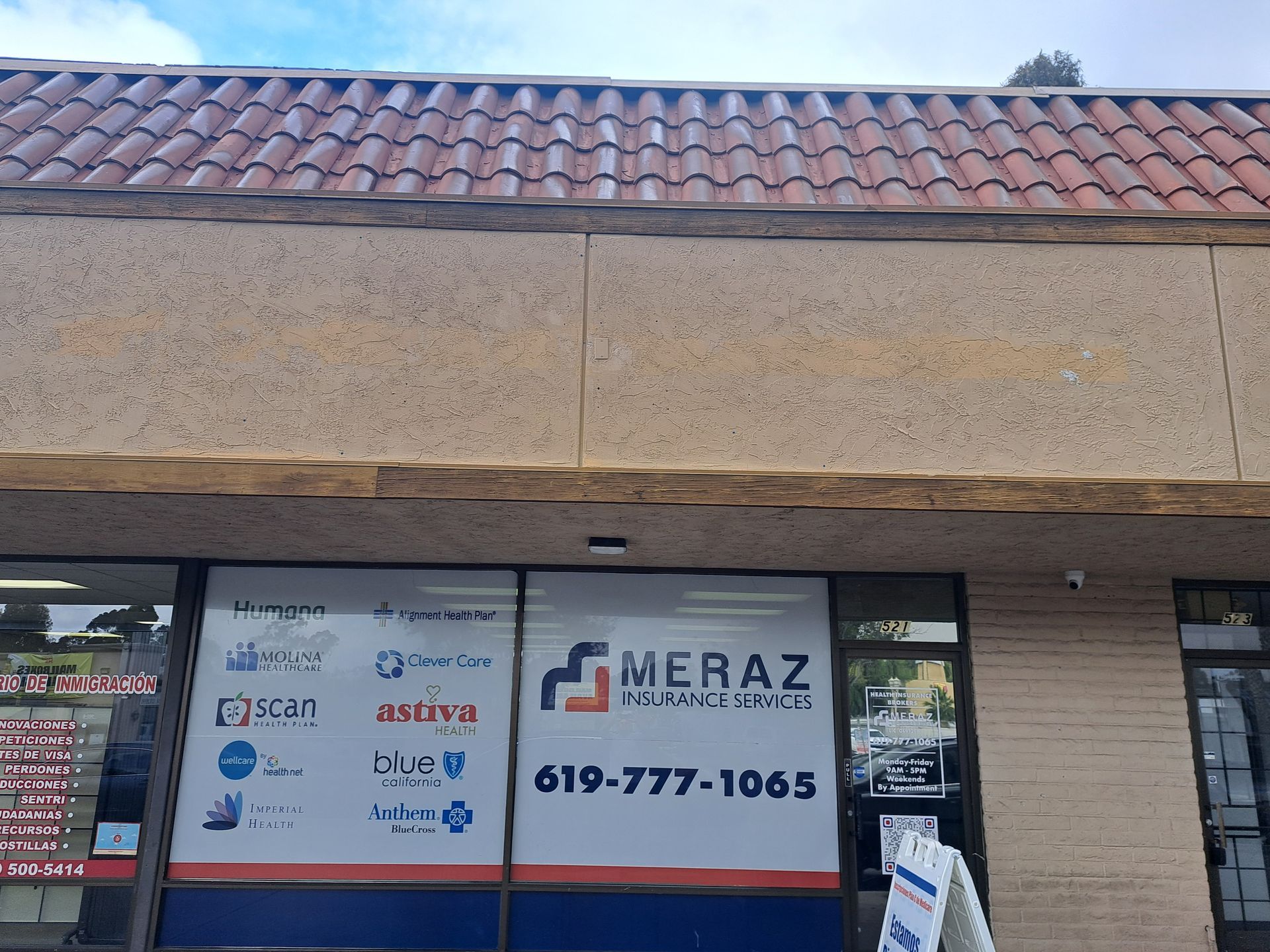 Storefront with MERAZ sign and phone number, plus several small service logos on the window.